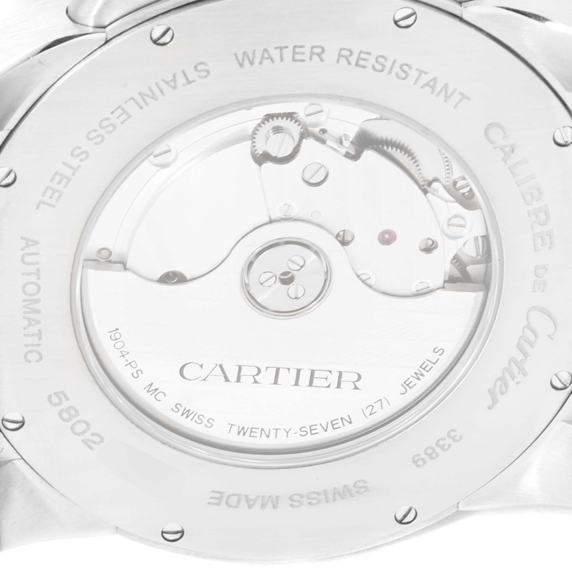 The image shows the back of a Calibre de Cartier watch by Cartier, highlighting its automatic movement and stainless steel case.