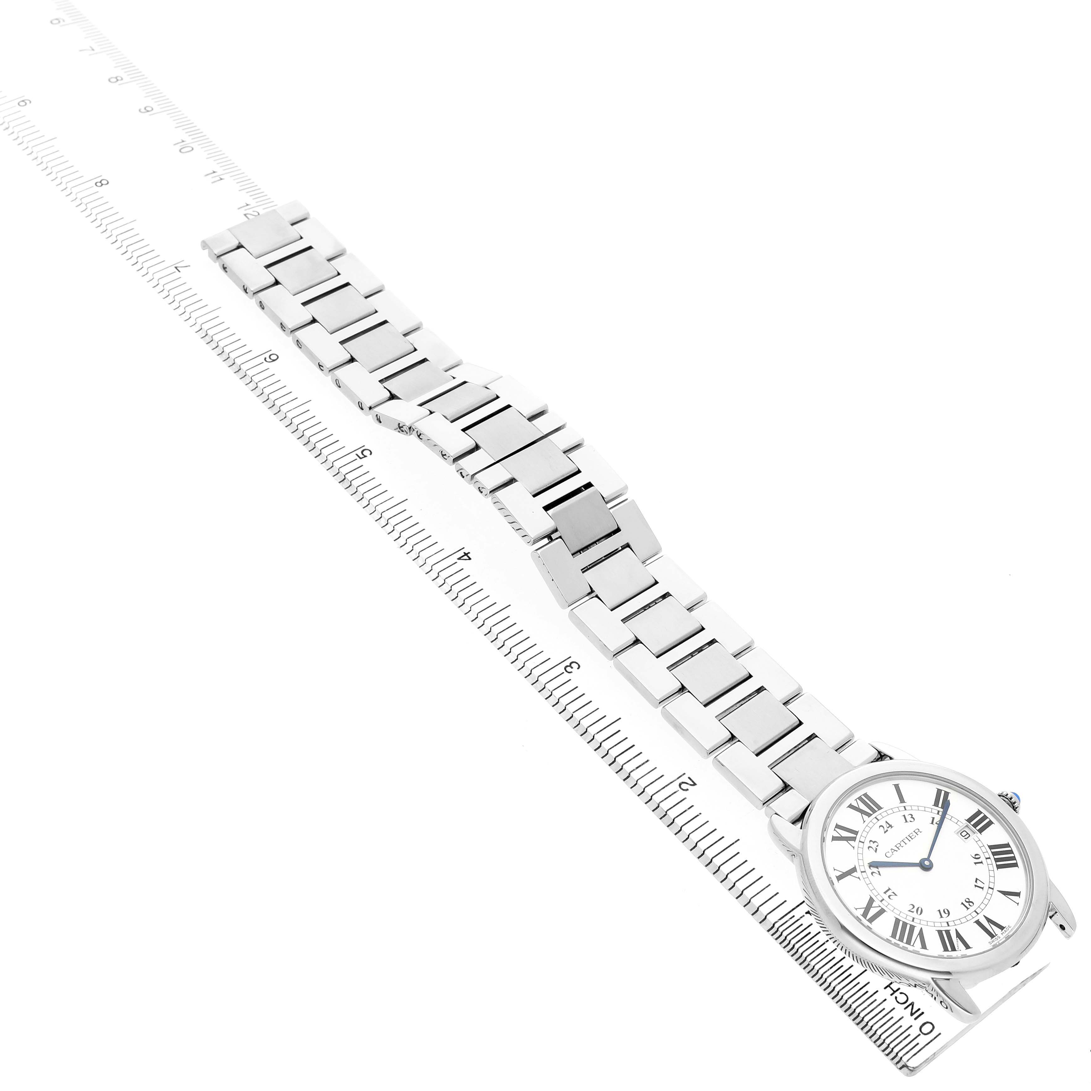 The Cartier Ronde W6701005 Men's Stainless Steel Silver Dial watch is shown from an angled top view, highlighting its bracelet and face alongside a ruler.