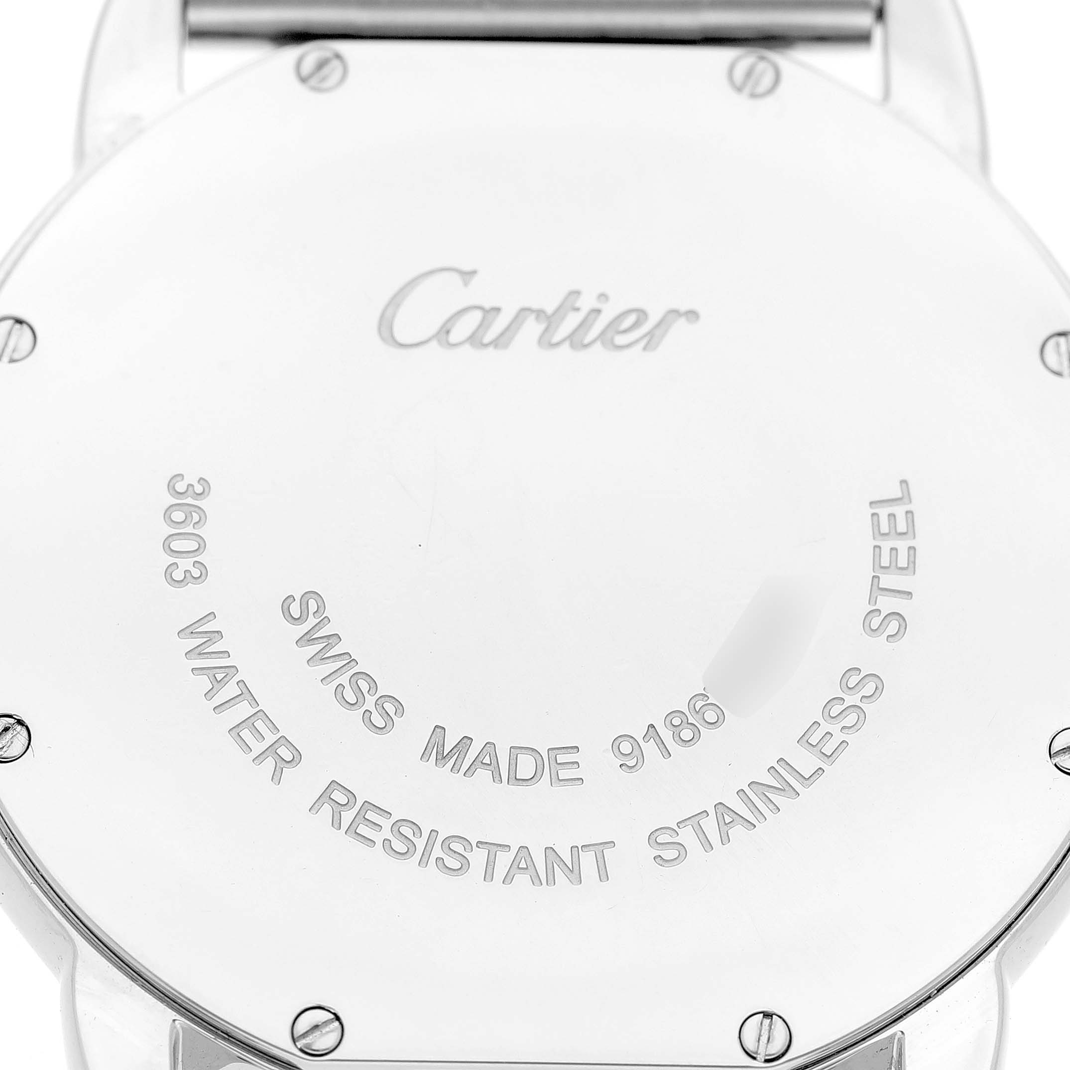 The image shows the back of a Cartier Ronde W6701005 Men's Stainless Steel Silver Dial watch, highlighting the engraving details and screw fastenings.