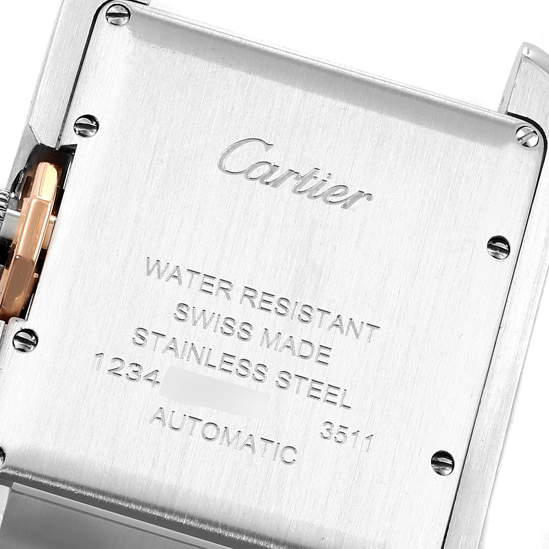 The image shows the caseback of the Cartier Tank Anglaise W5310007 Women
s Steel and Gold (two tone) Silver Dial W5310007 Women
s Steel and Gold (two tone) Silver Dial watch, displaying engraved details and part of the crown.