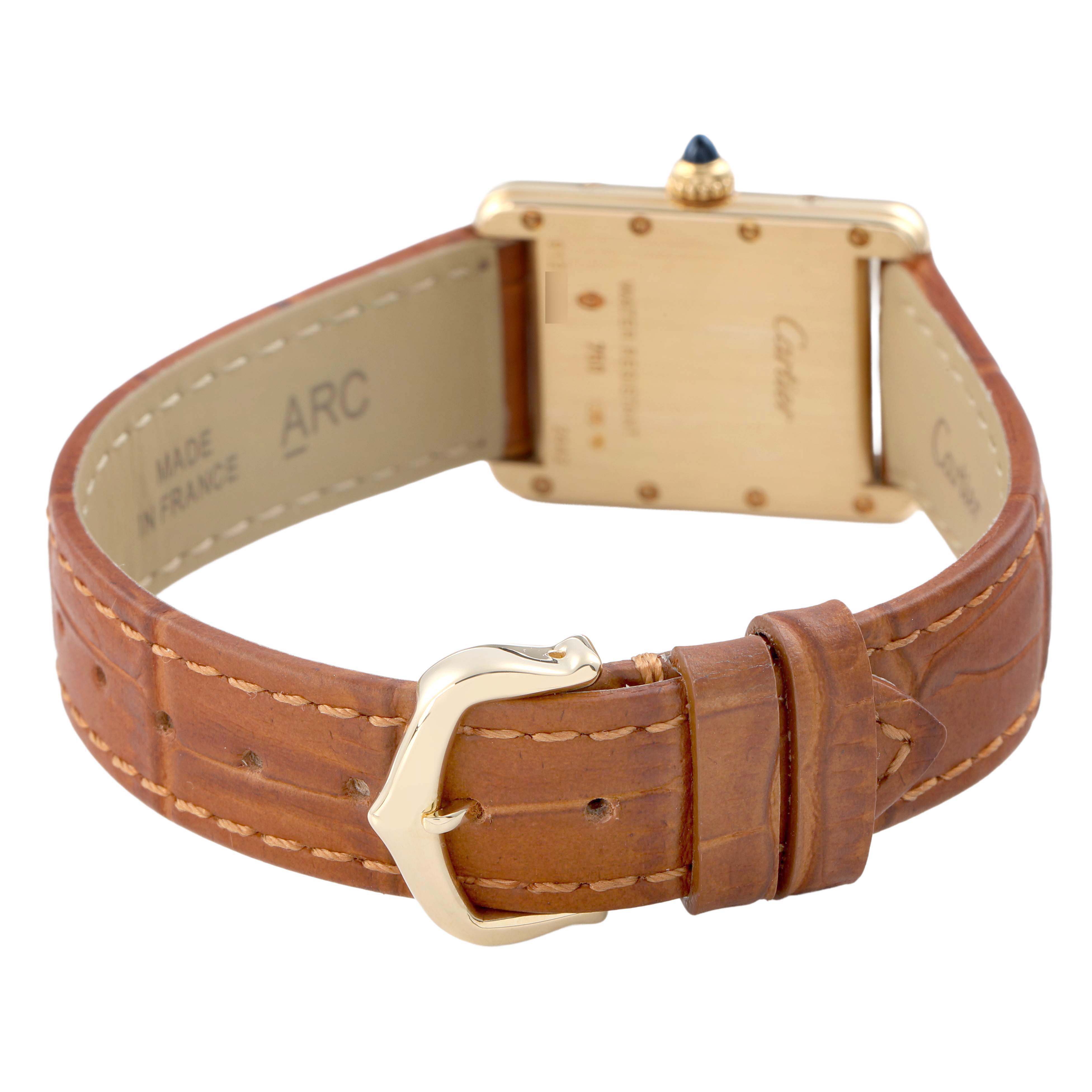 The Cartier Tank Louis W1529856 Women's Yellow Gold Silver Dial watch is shown from the back, highlighting its gold case, leather strap, and buckle.