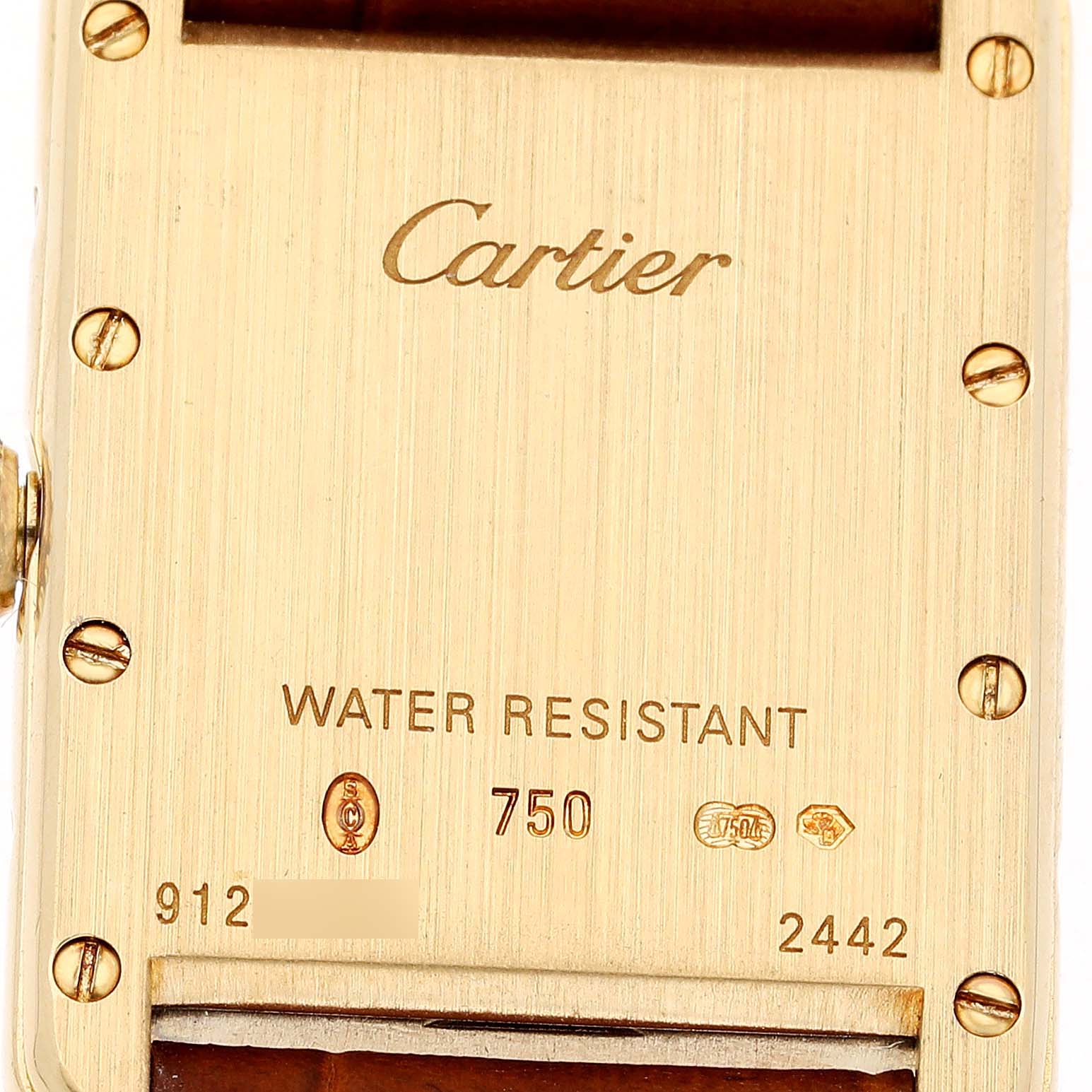 The image shows the back case of a Cartier Tank Louis W1529856 Women's Yellow Gold Silver Dial watch, highlighting the brand name and metal markings.