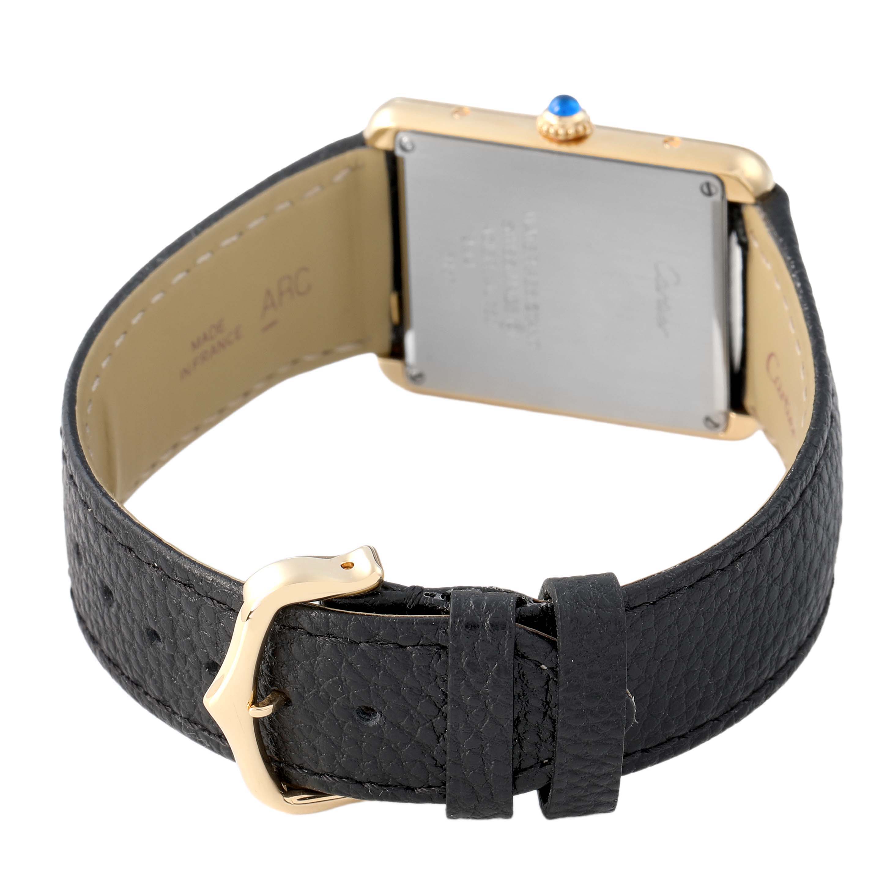 The image shows the back of a Cartier Tank Solo W5200004 Men's Yellow Gold Red Dial watch, featuring its leather strap and buckle.