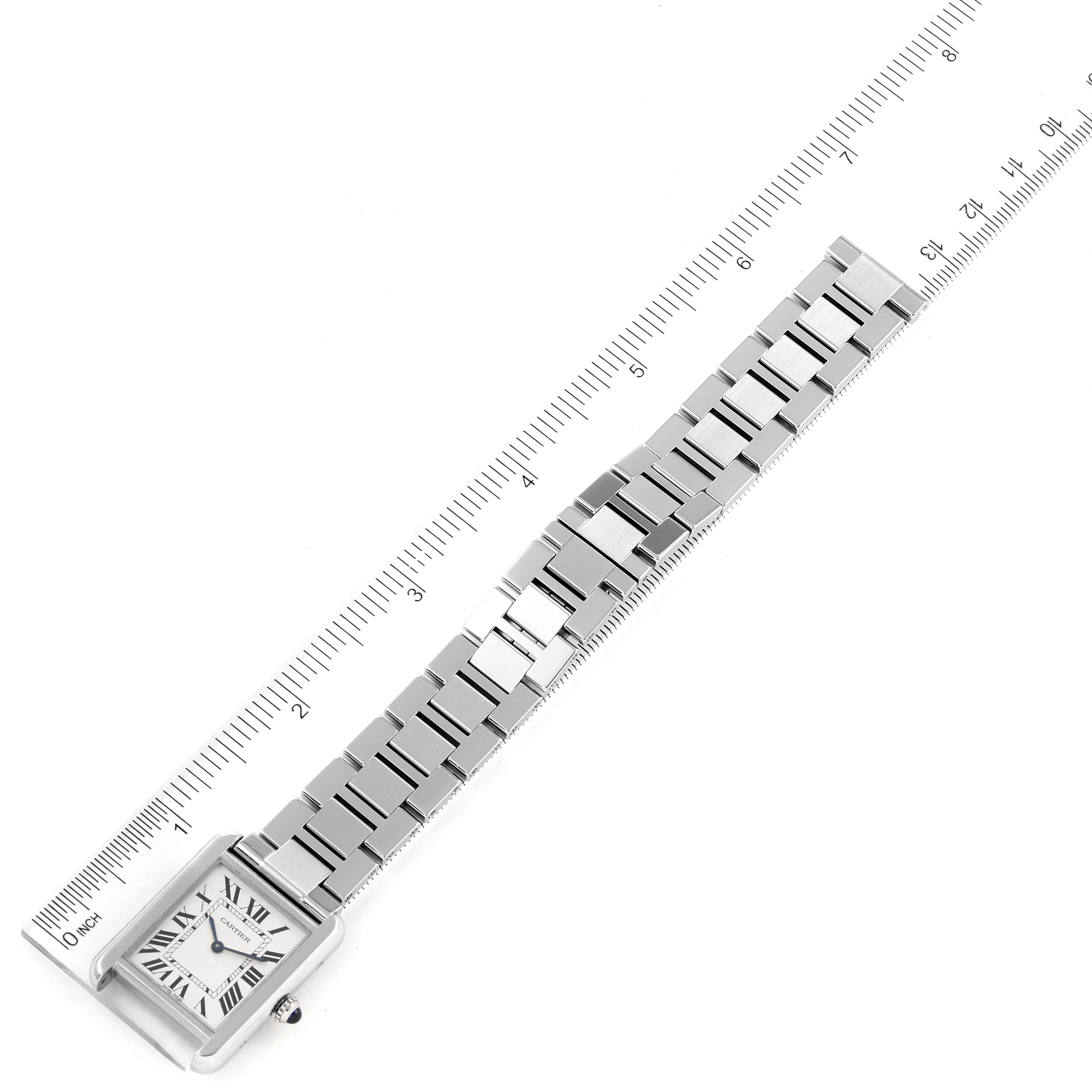 The image shows a Cartier Tank Solo W5200013 Women
s Stainless Steel Silver Dial W5200013 Women
s Stainless Steel Silver Dial watch laid flat against a ruler, highlighting its full length and bracelet.