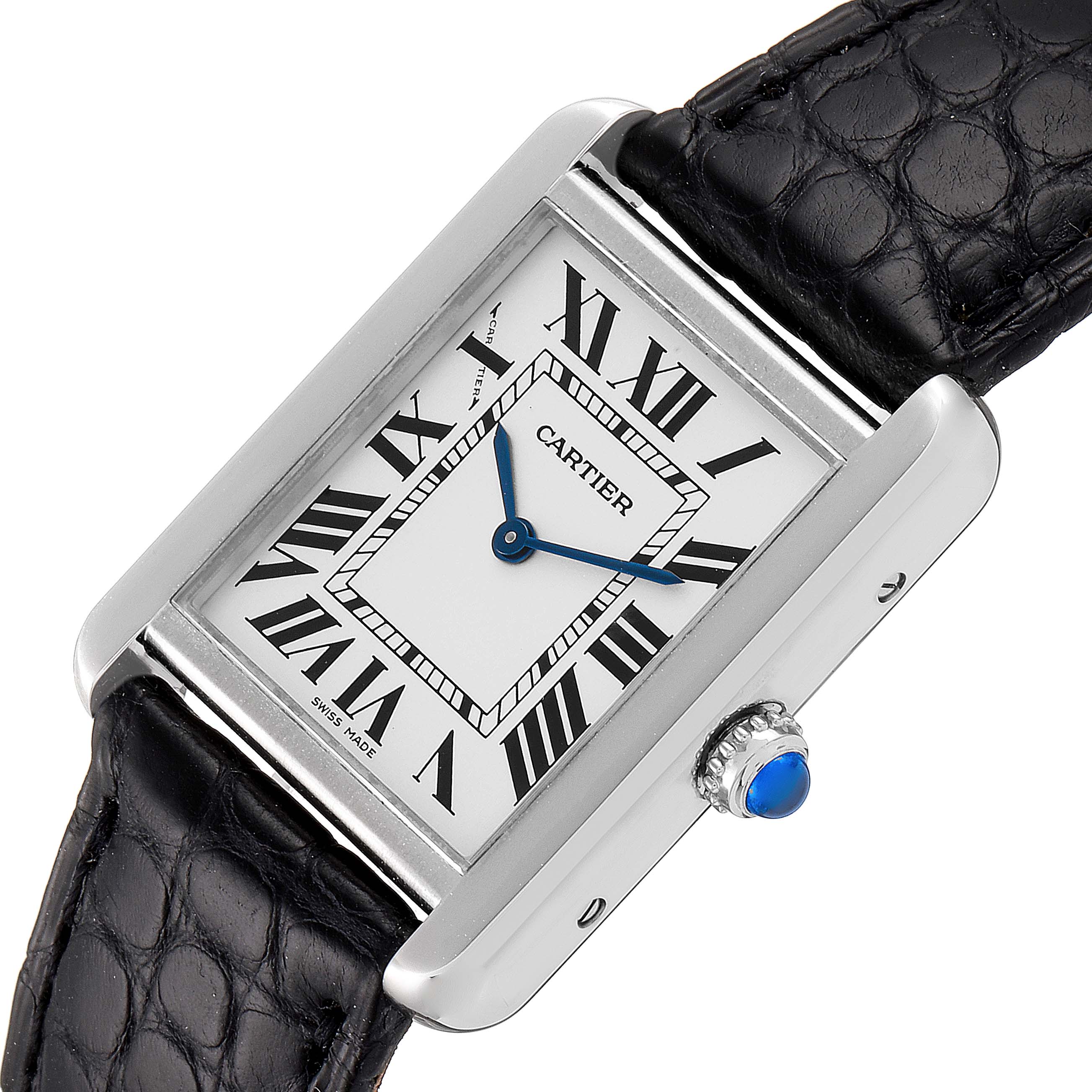 The image shows a close-up, angled view of a Cartier Tank Solo W1018255 Women
s Stainless Steel Silver Dial W1018255 Women
s Stainless Steel Silver Dial watch, displaying the face, bezel, strap, and crown with a blue gemstone.