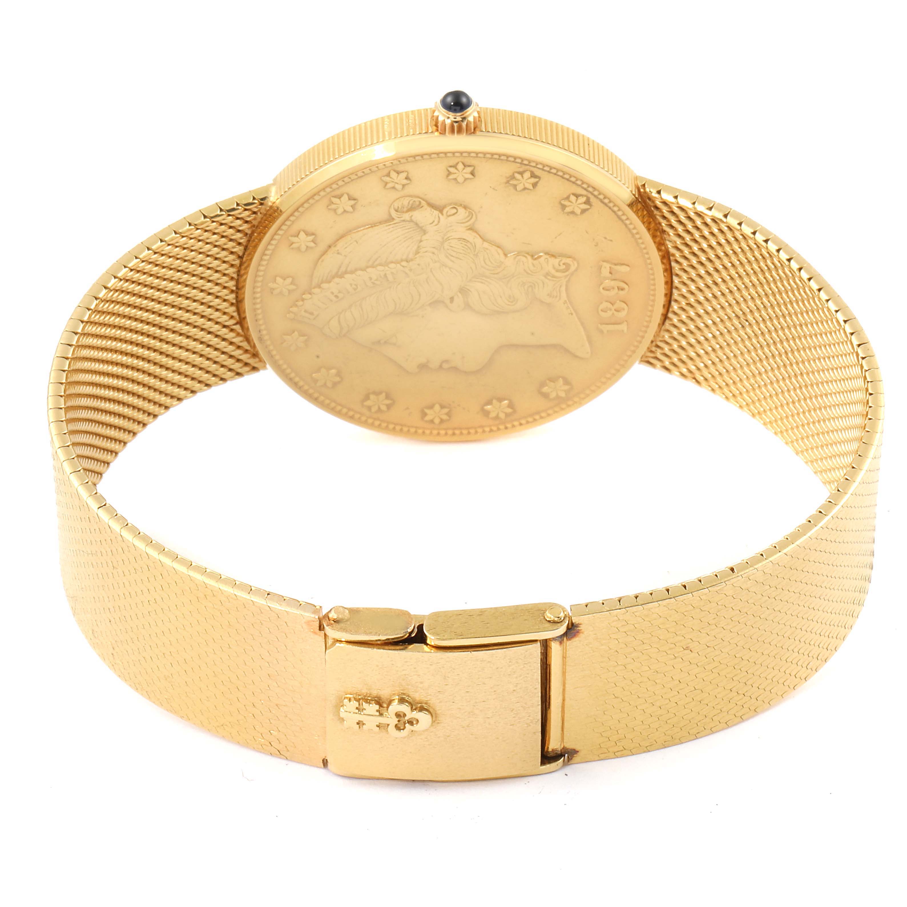 This Corum Coin Watch 1897 Men's Yellow Gold Black Dial 1897 Men's Yellow Gold Black Dial model is shown from the back, displaying the detailed coin face and the clasp of the gold mesh bracelet.