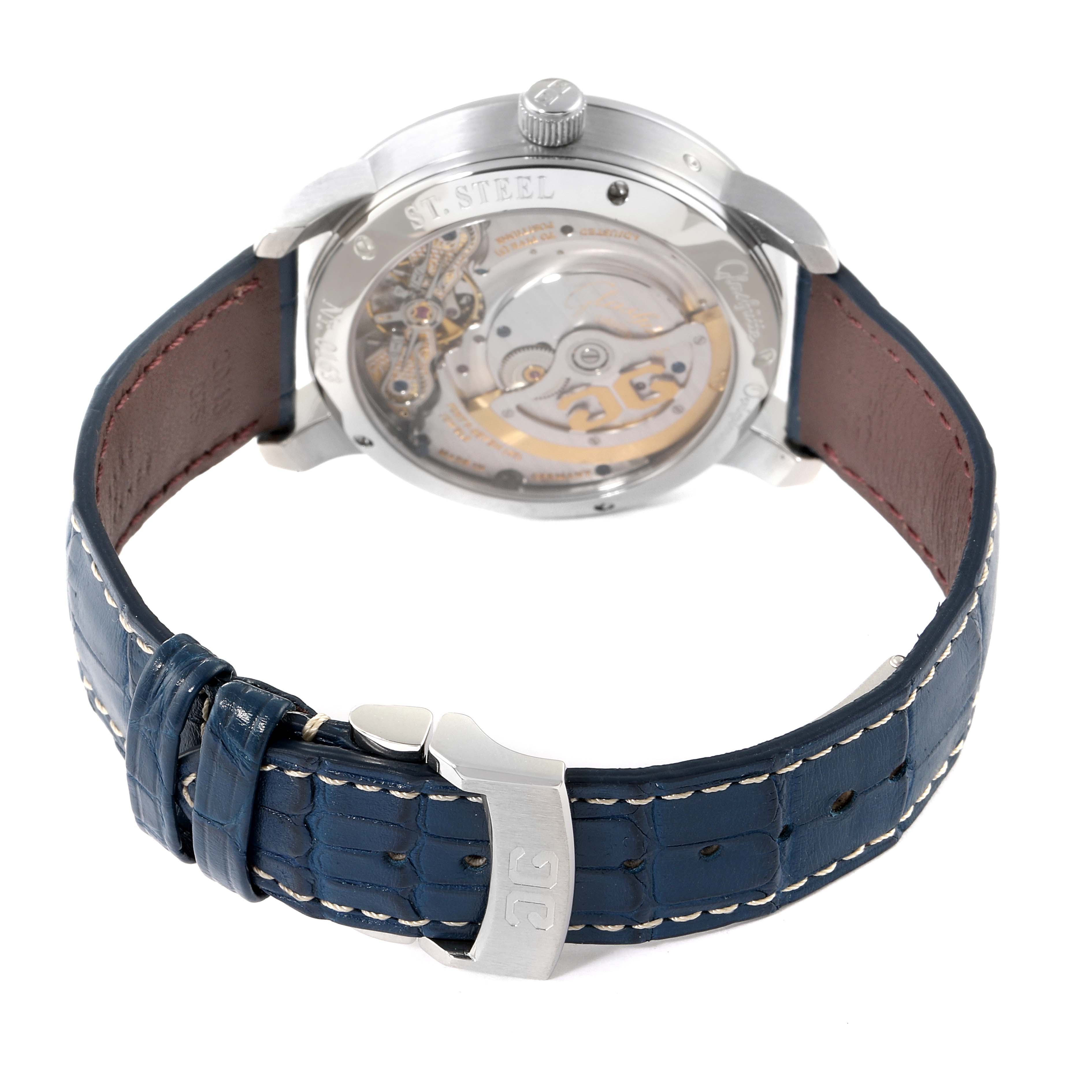 The image shows the back view of a Glashütte Pano watch, highlighting its movement and blue leather strap with a clasp.