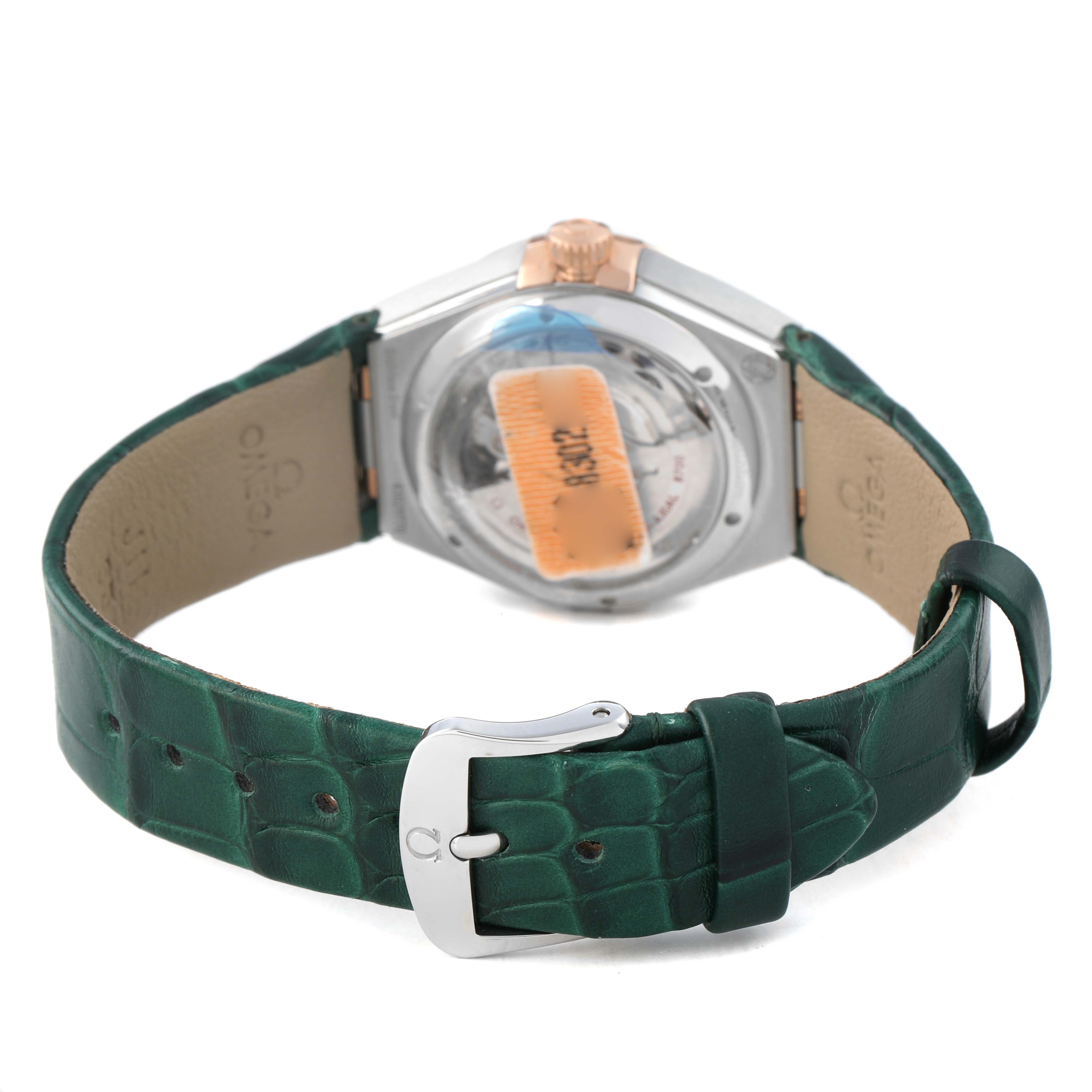 The Omega 131.23.29.20.99.001 Women's Steel and Gold (two tone) Green Dial Constellation 29 Diamond Steel Rose Gold watch is shown from the back, highlighting its green leather strap and buckle.