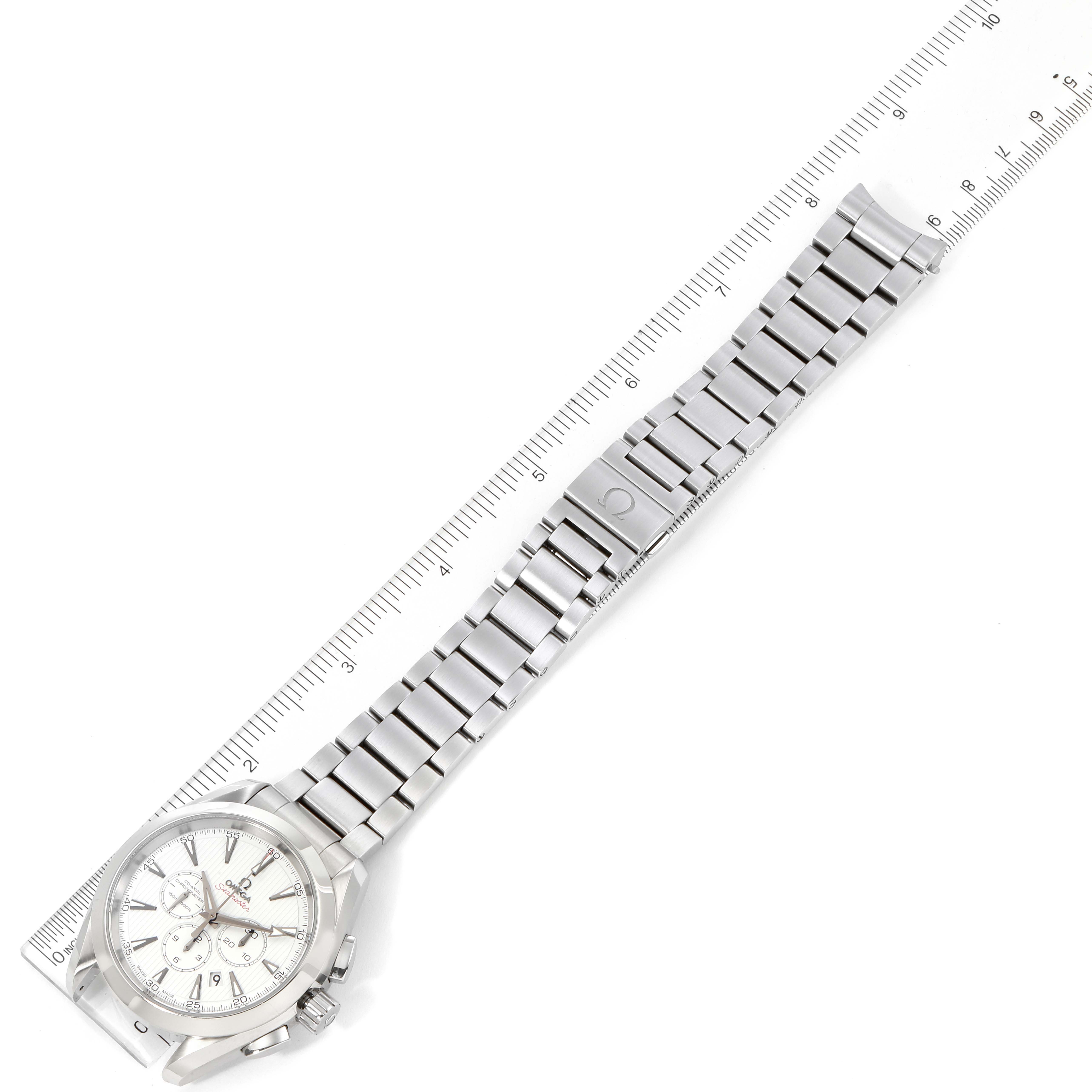 The image shows an Omega Aqua Terra 231.10.44.50.04.001 Men
s Stainless Steel White Dial 231.10.44.50.04.001 Men
s Stainless Steel White Dial watch laid flat, with a ruler measuring its stainless steel band length and width.