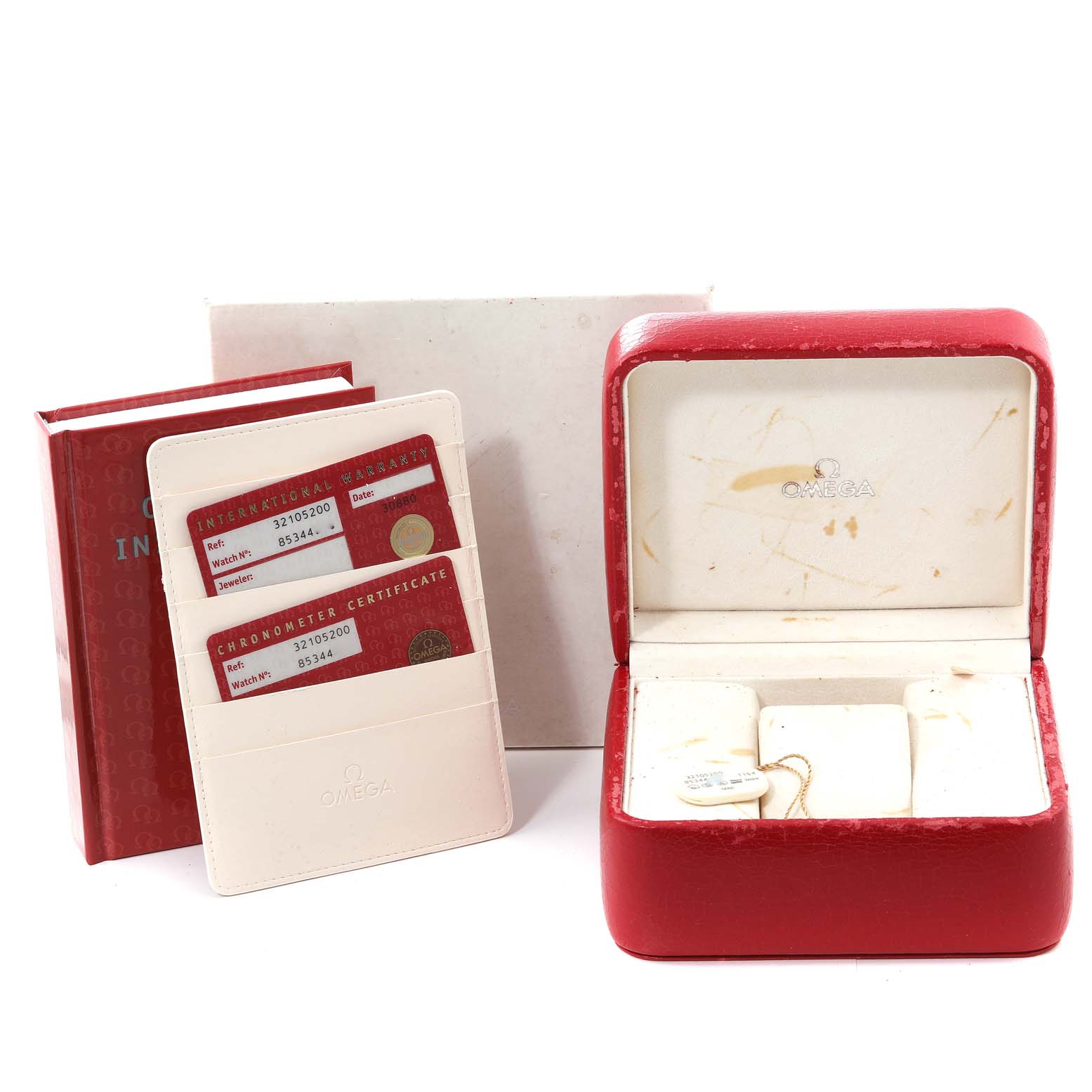 The image shows the accessories for an Omega Speedmaster 3210.52.00 Men
s Stainless Steel Black Dial 3210.52.00 Men
s Stainless Steel Black Dial, including the red watch box, warranty cards, and an instruction manual.