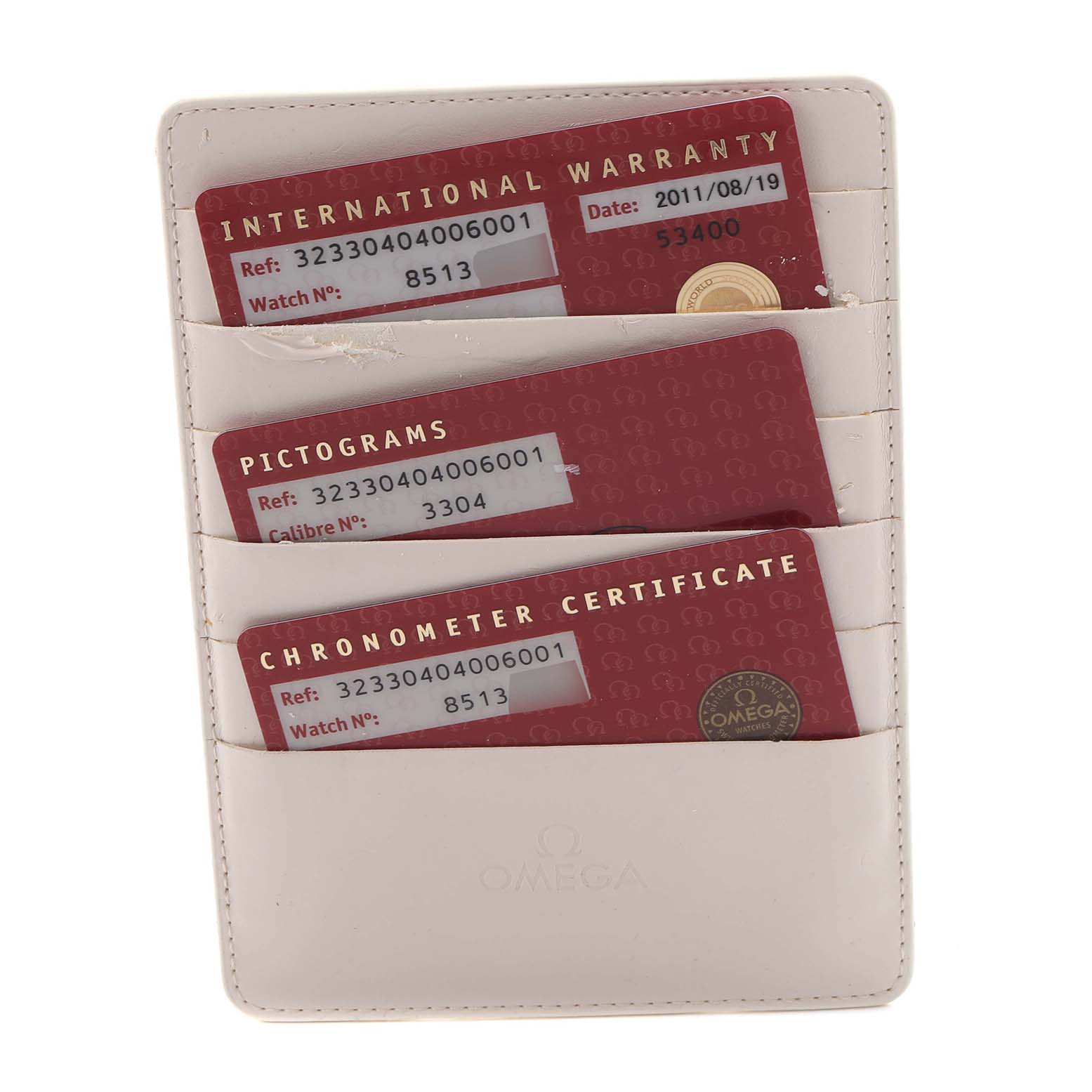 The image shows warranty and certification cards for an Omega Speedmaster 323.30.40.40.06.001 Men's Stainless Steel Grey Dial 323.30.40.40.06.001 Men's Stainless Steel Grey Dial, displayed in a white cardholder.