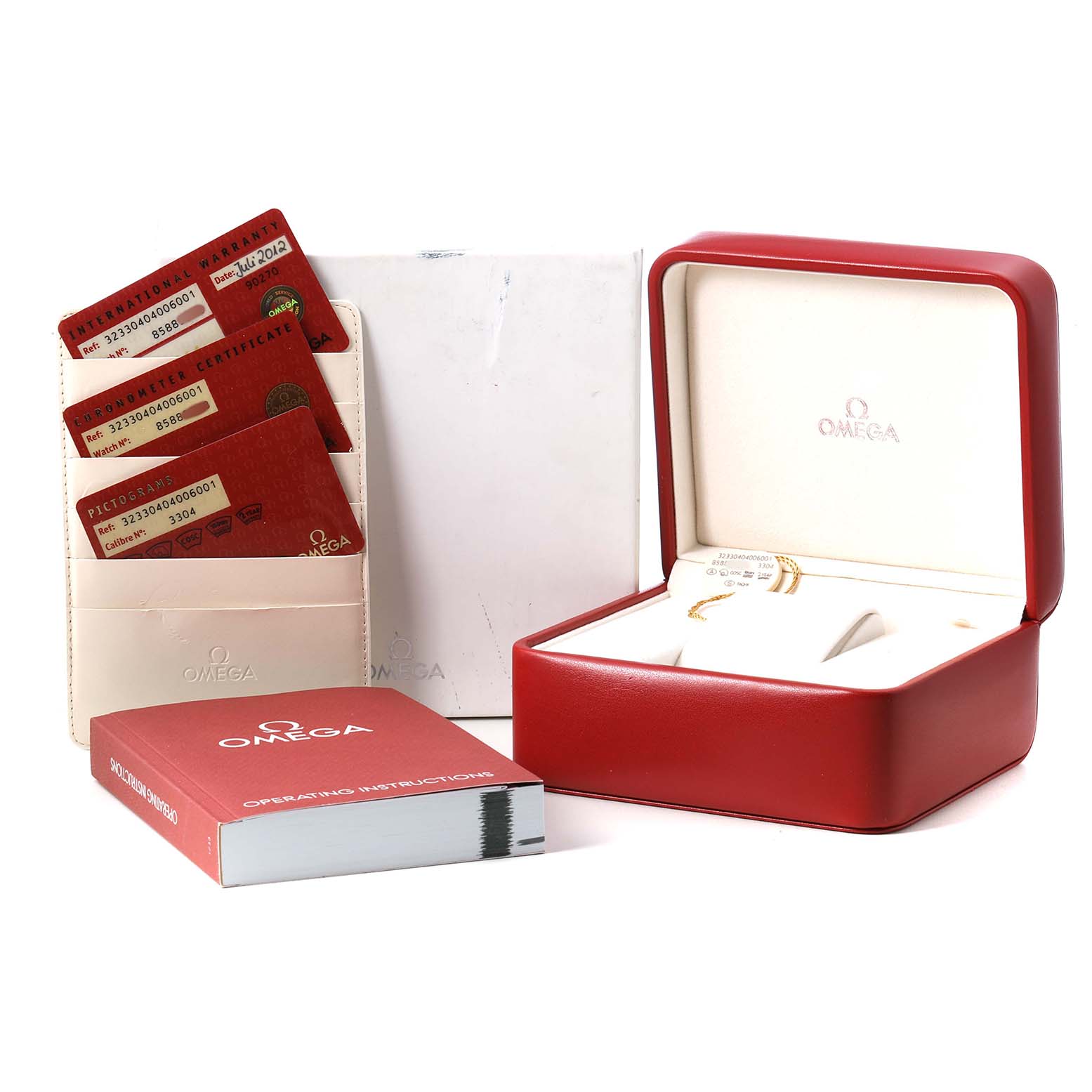 The image shows the Omega Speedmaster 323.30.40.40.06.001 Men's Stainless Steel Grey Dial packaging, warranty cards, and operating instructions from a front angled view.