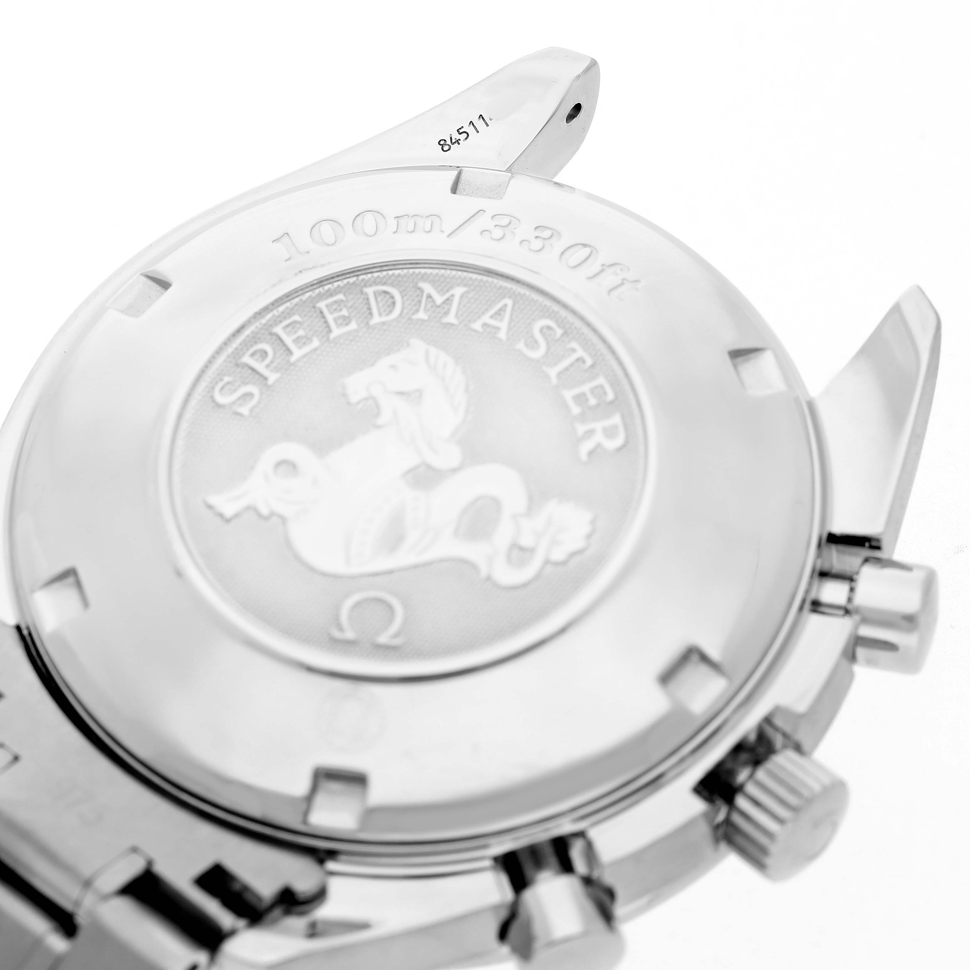 The image shows the back view of the Omega Speedmaster 3221.30.00 Men's Stainless Steel Silver Dial, highlighting the engraved case back and part of the bracelet.