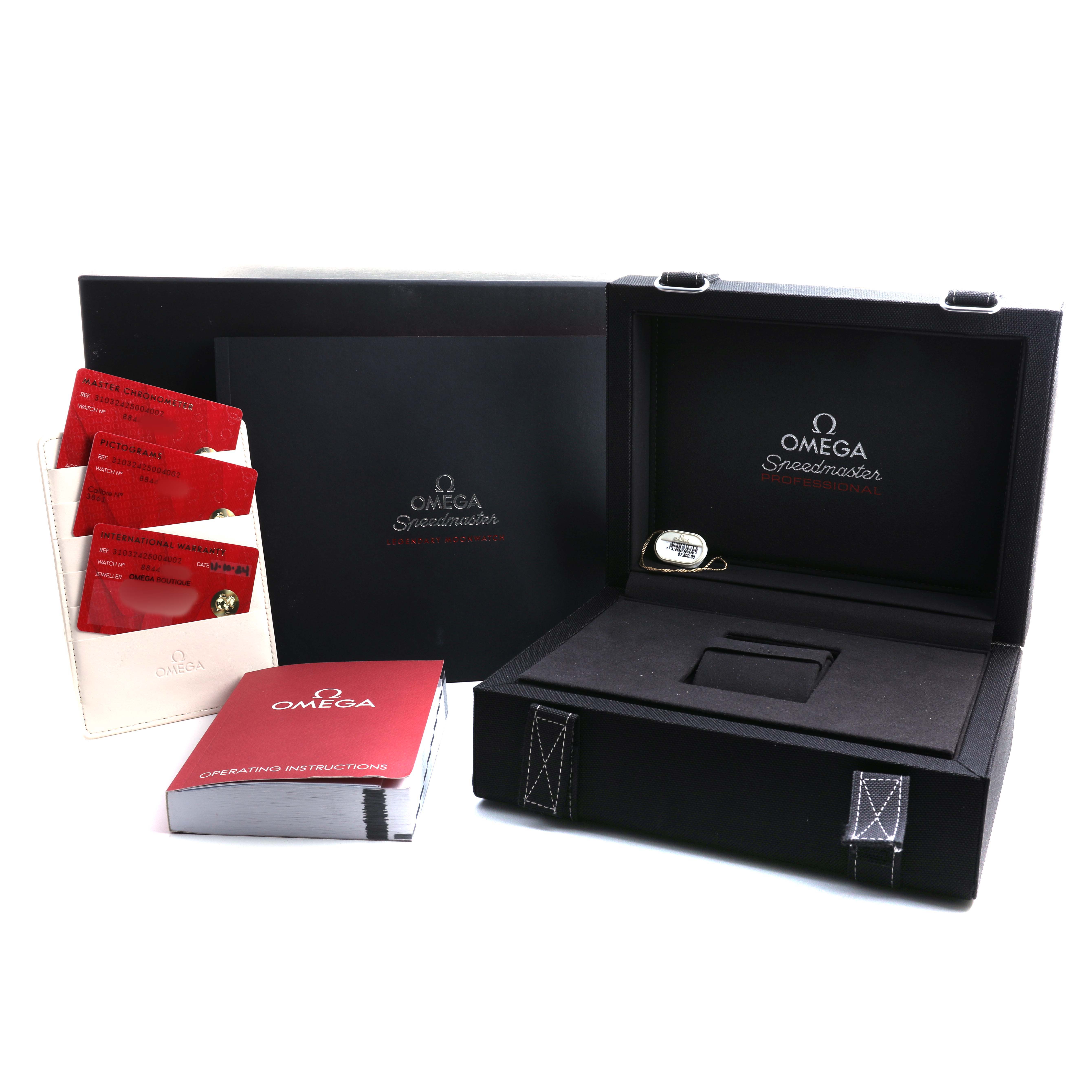 The image shows the packaging and accessories of the Omega Speedmaster 310.32.42.50.04.002 Men's Stainless Steel White Dial, including the box, instruction manual, and cards.