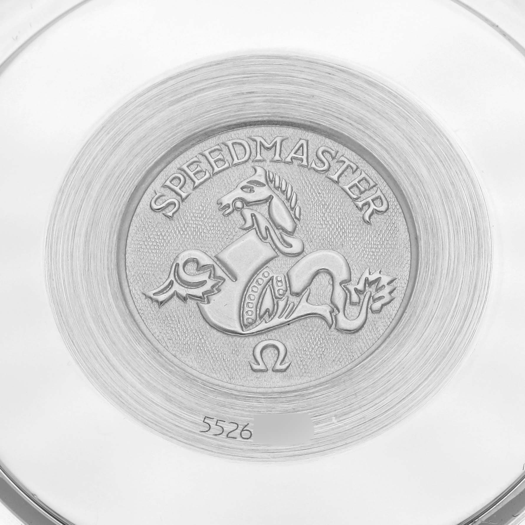The image shows the back case emblem of an Omega Speedmaster 3510.61.00 Men's Stainless Steel Red Dial 3510.61.00 Men's Stainless Steel Red Dial watch featuring a horse and branding details.