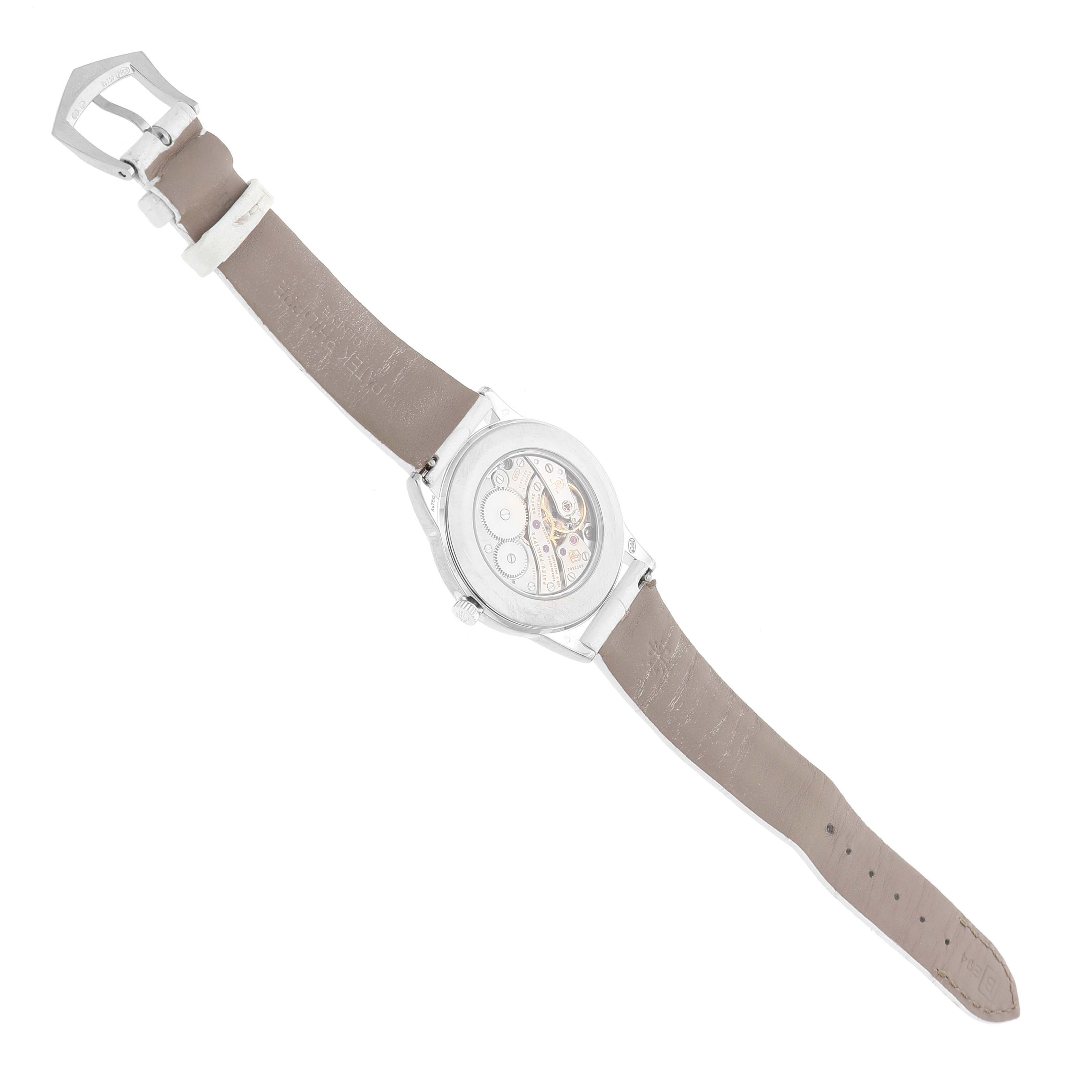 The image shows the back view of a Patek Philippe Calatrava 7122/200G-001 Women's White Gold White Dial watch, highlighting the movement and brown leather strap.