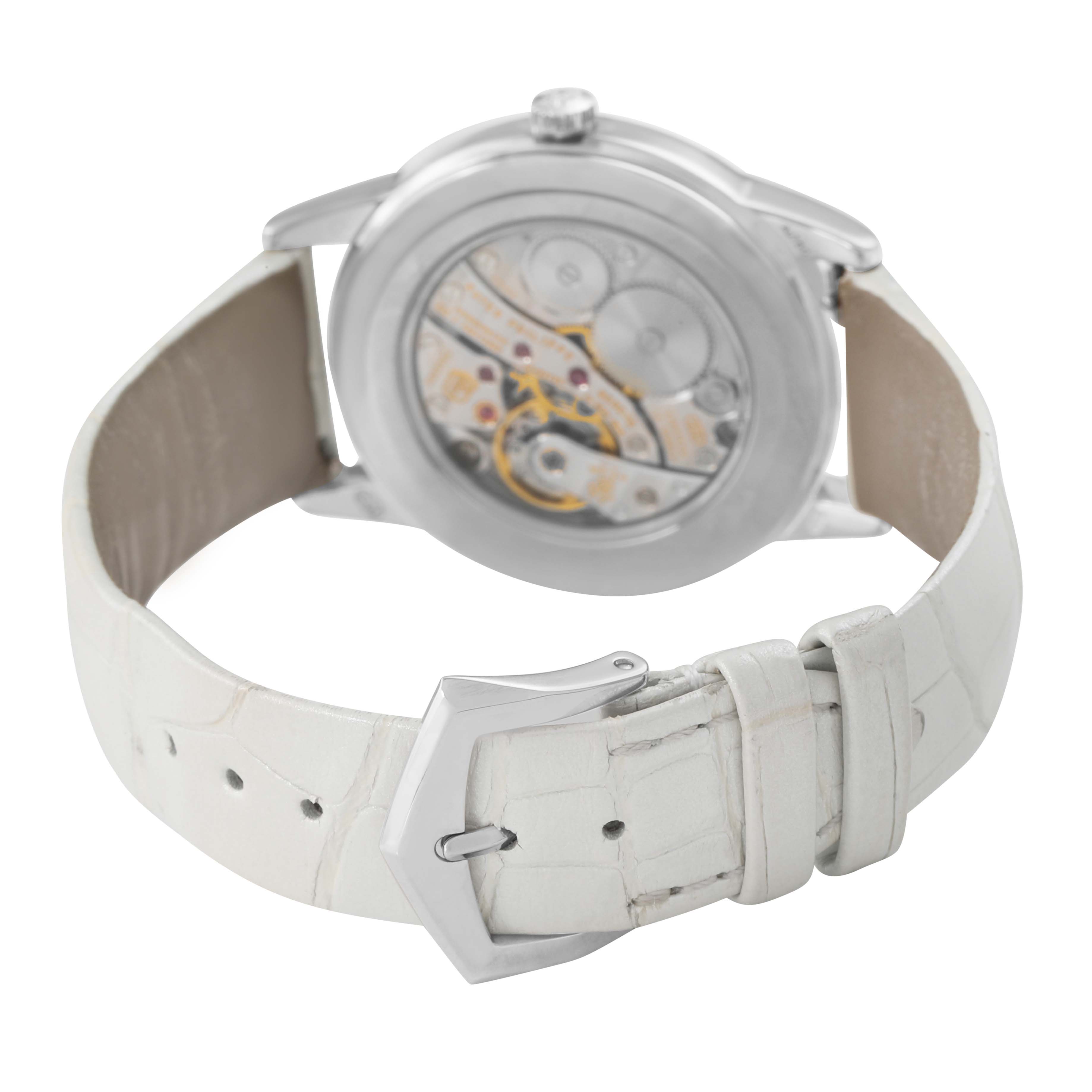 The image shows the back view of a Patek Philippe Calatrava 7122/200G-001 Women's White Gold White Dial watch, highlighting its movement and white leather strap.