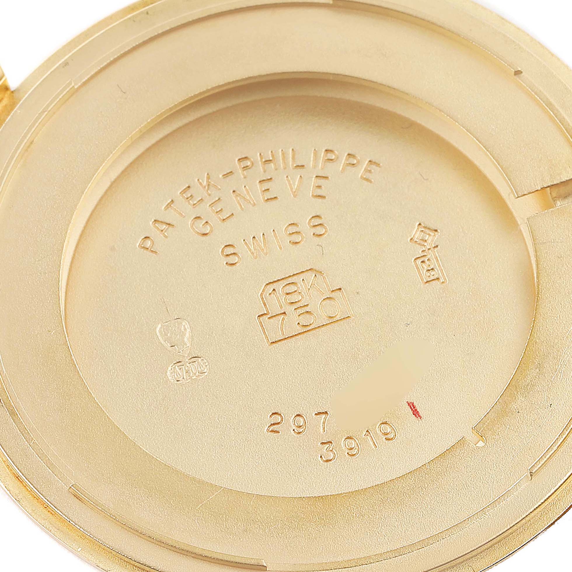 The image shows the inside case back of a Patek Philippe Calatrava 3919J Men's Yellow Gold White Dial 3919J Men's Yellow Gold White Dial watch, highlighting the brand engravings and metal hallmarks.