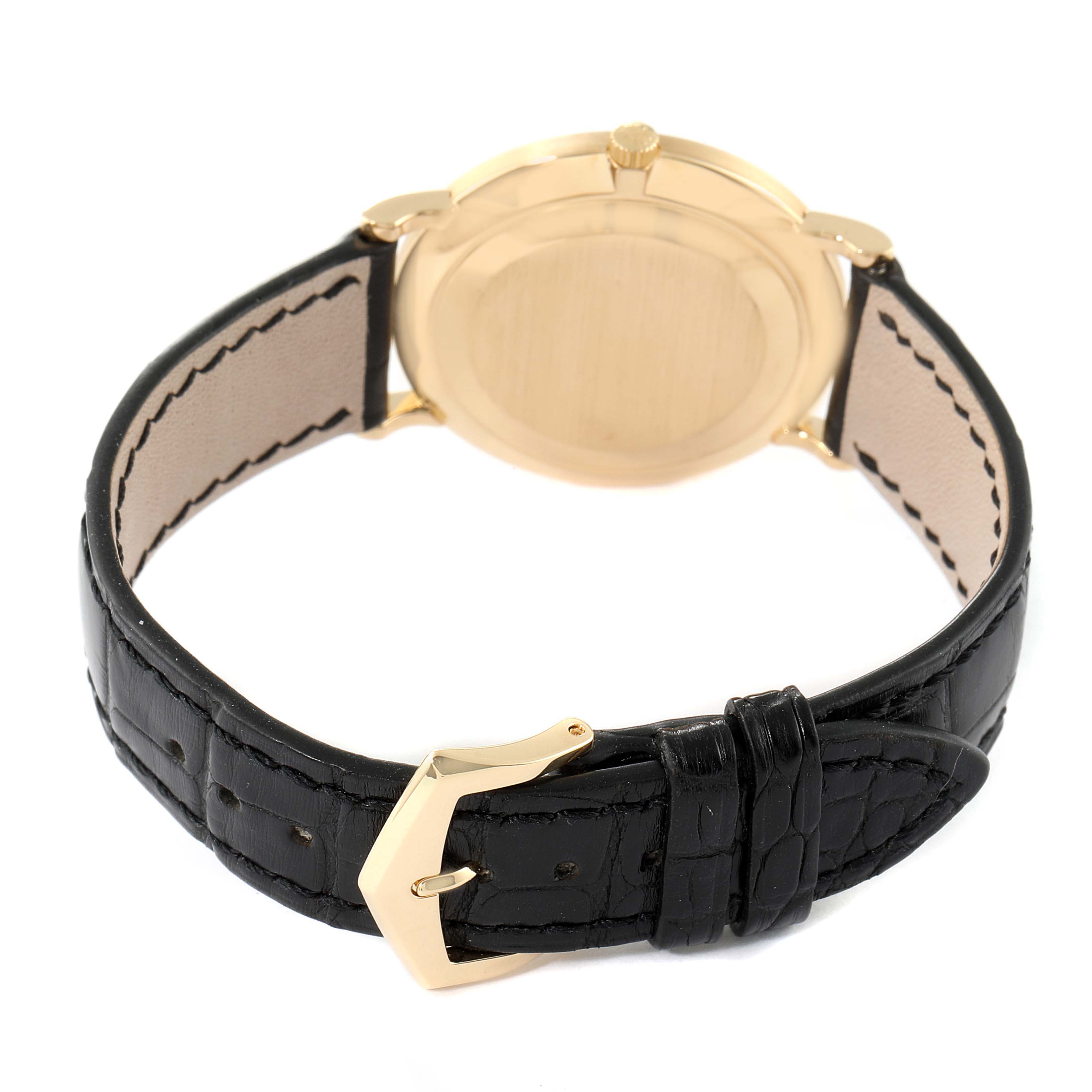 This image shows the back view of a Patek Philippe Calatrava 3919J Men's Yellow Gold White Dial 3919J Men's Yellow Gold White Dial watch with a black leather strap and gold buckle.