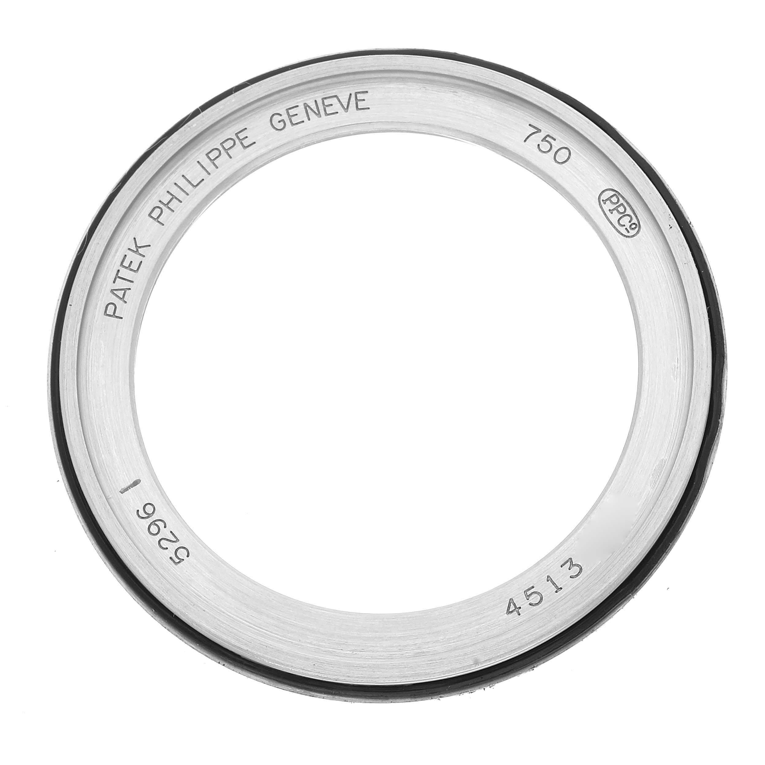 This image shows a top-down view of the bezel for a Patek Philippe Calatrava 5296G Men's White Gold Silver Dial 5296G Men's White Gold Silver Dial watch, displaying inscriptions and serial numbers.