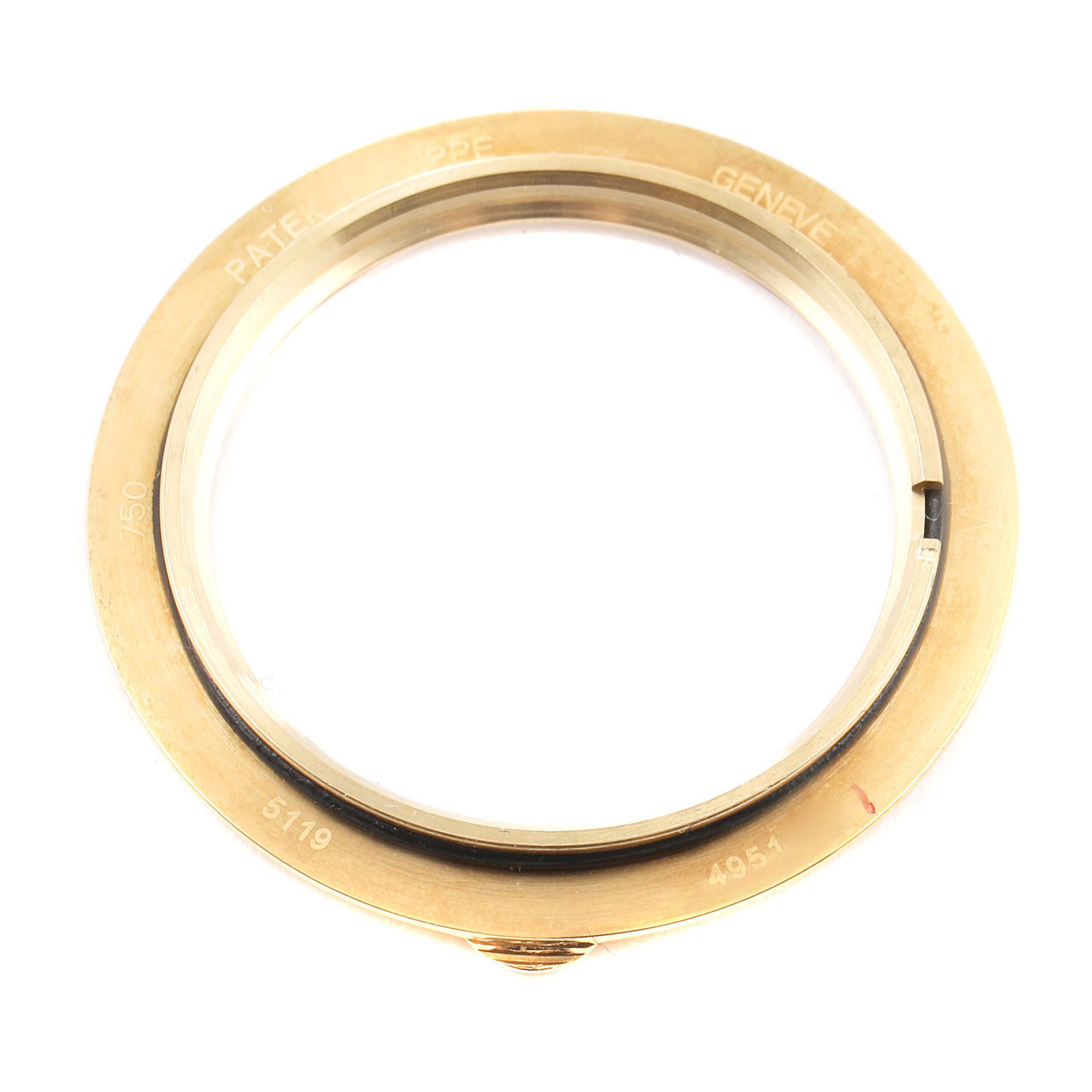 The image shows the bezel of a Patek Philippe Calatrava 5119J Men's Yellow Gold White Dial 5119J Men's Yellow Gold White Dial watch from a top-down angle.