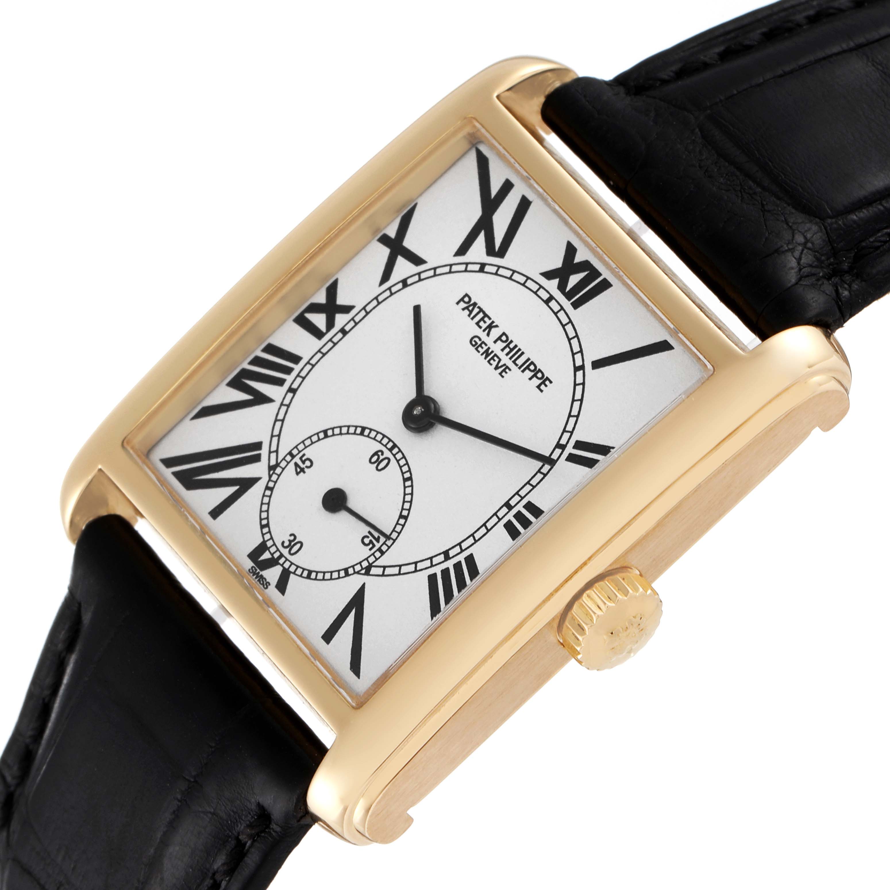 The Patek Philippe Gondolo 5014J Men's Yellow Gold Silver Dial 5014J Men's Yellow Gold Silver Dial watch is shown at an angled top view, highlighting its rectangular face, crown, and black leather strap.