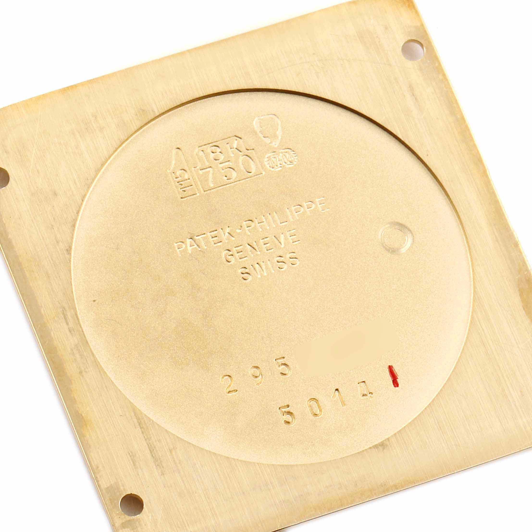 This image shows the back cover of a Patek Philippe Gondolo 5014J Men's Yellow Gold Silver Dial 5014J Men's Yellow Gold Silver Dial watch, highlighting the engravings and material details.