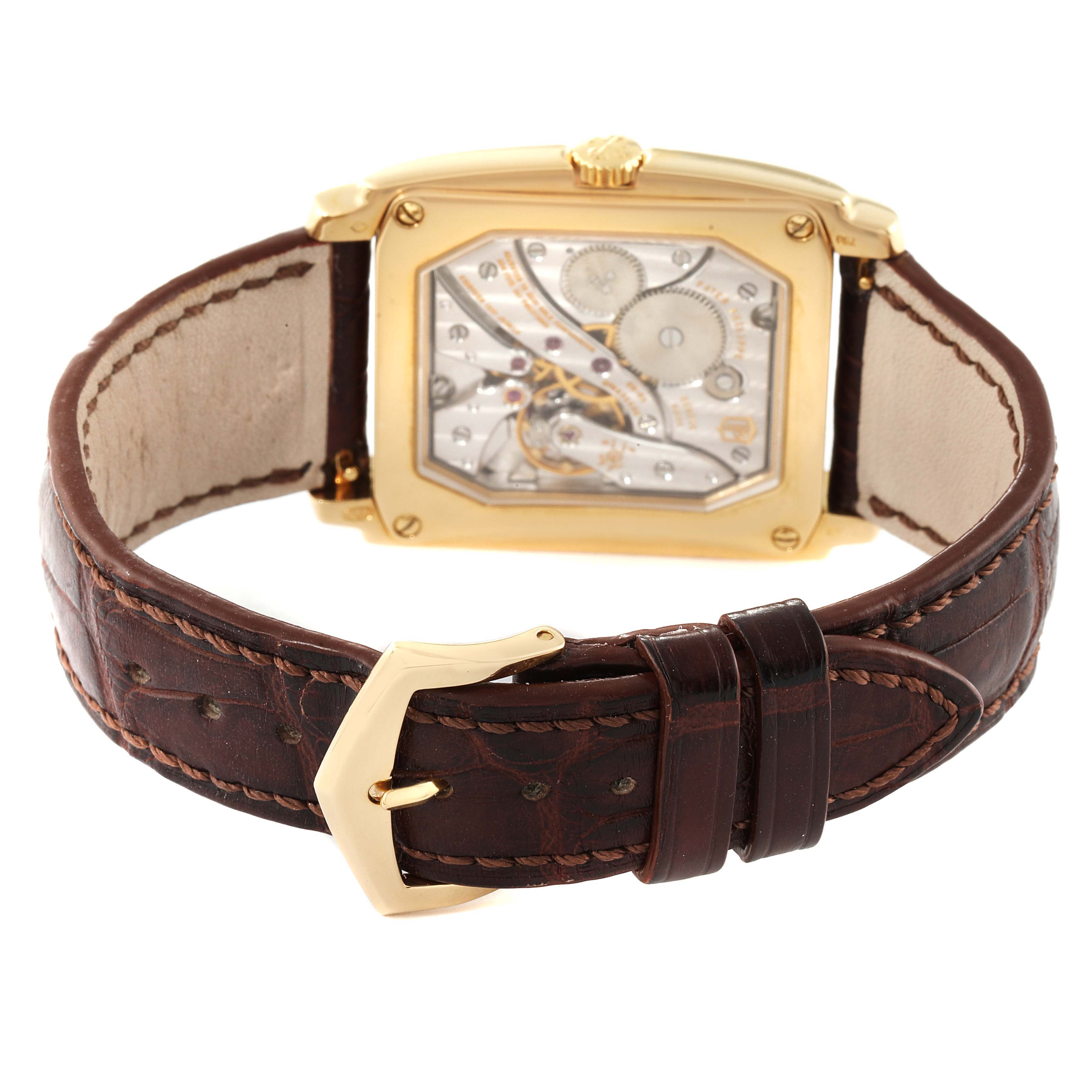 This is the back view of the Patek Philippe Gondolo 5124J Men's Yellow Gold Silver Dial 5124J Men's Yellow Gold Silver Dial watch, showing its exhibition case back and leather strap with a gold buckle.