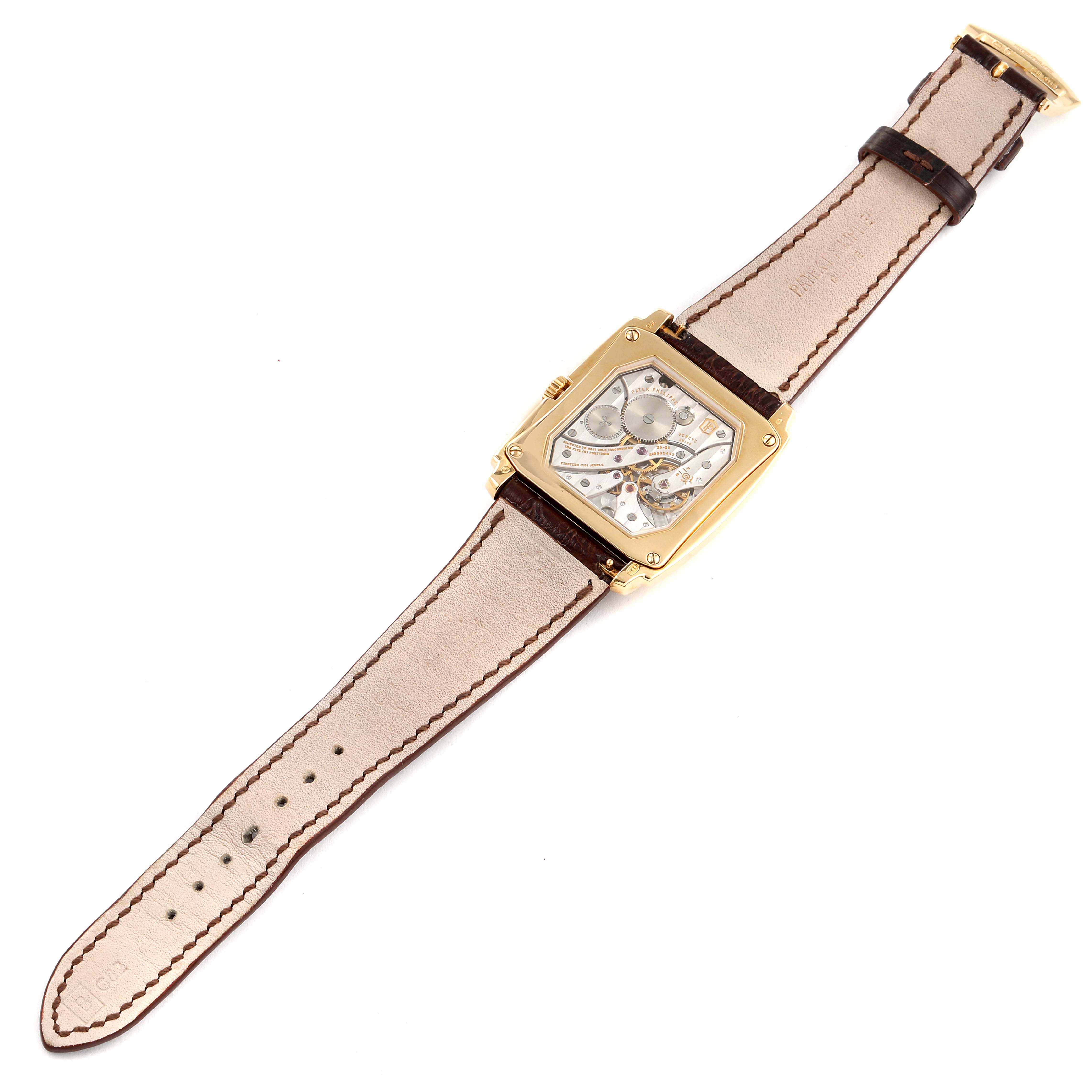 The image shows a top view of a Patek Philippe Gondolo 5124J Men's Yellow Gold Silver Dial 5124J Men's Yellow Gold Silver Dial watch displaying the back and inside mechanism with its brown leather strap.