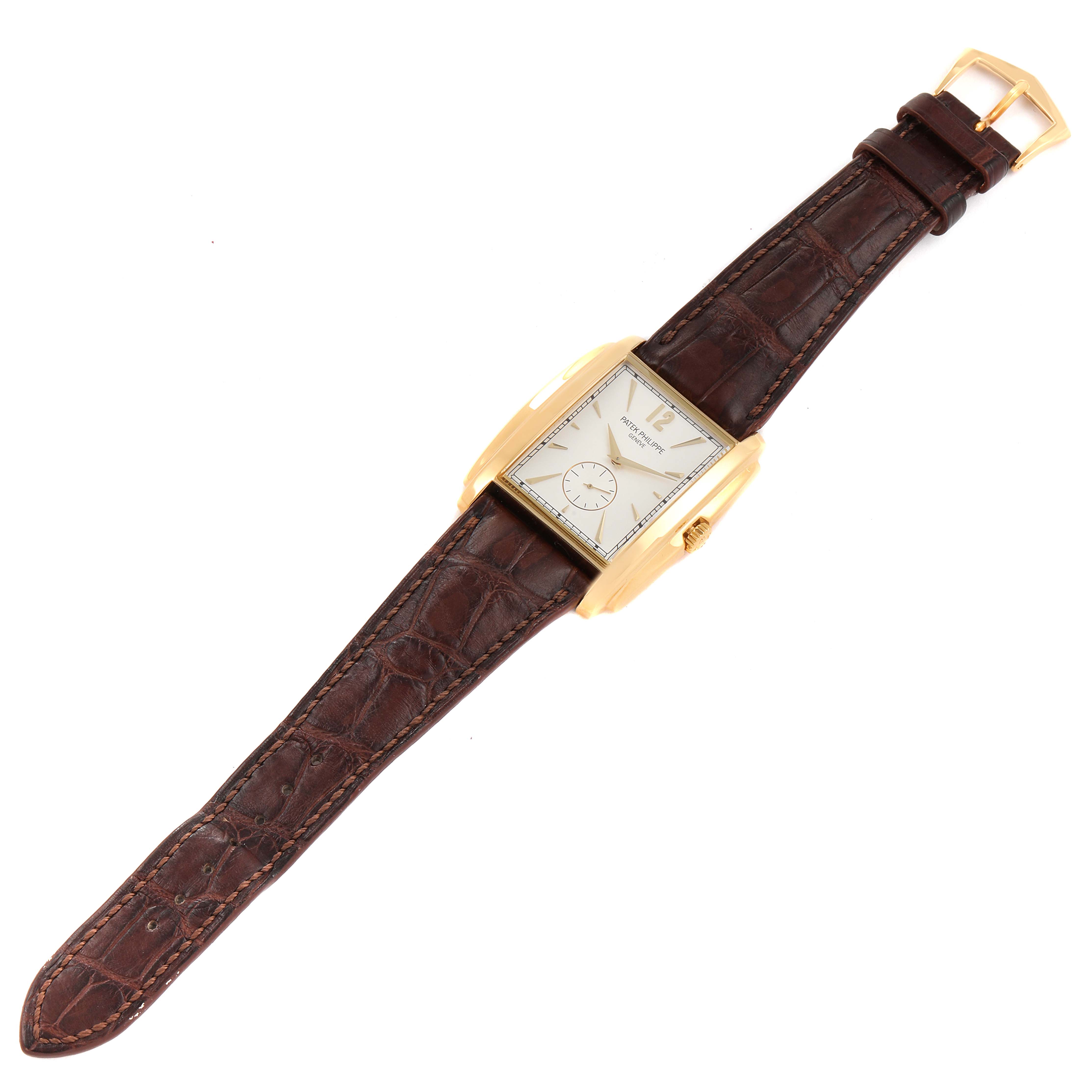 The image shows a top-down view of a Patek Philippe Gondolo 5124J Men's Yellow Gold Silver Dial 5124J Men's Yellow Gold Silver Dial watch, highlighting its brown strap and rectangular face.