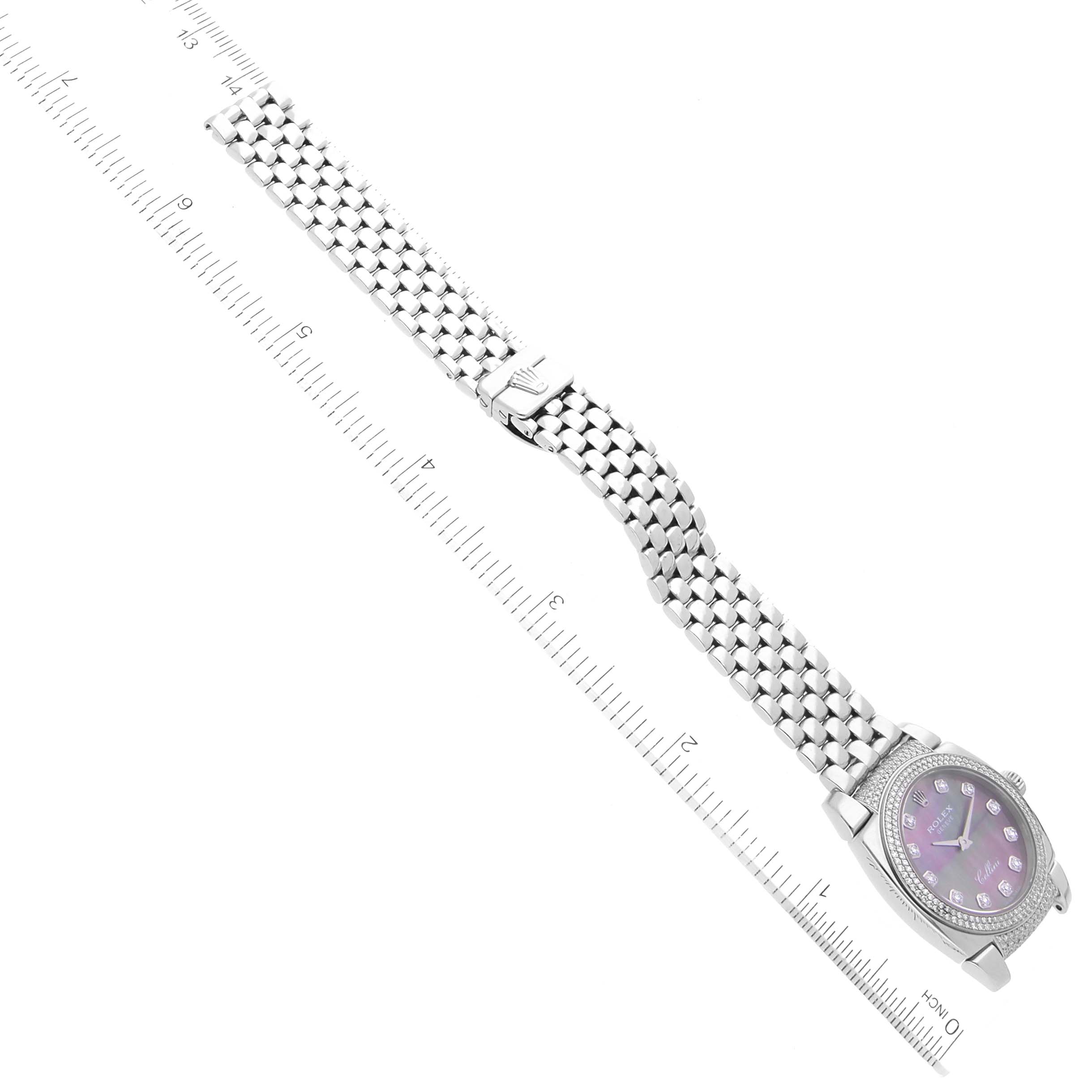 The Rolex Cellini 6311 Women's White Gold Mother of Pearl Dial 6311 Women's White Gold Mother of Pearl Dial watch is shown from an overhead angle, displaying its face, bracelet, and clasp alongside a ruler.