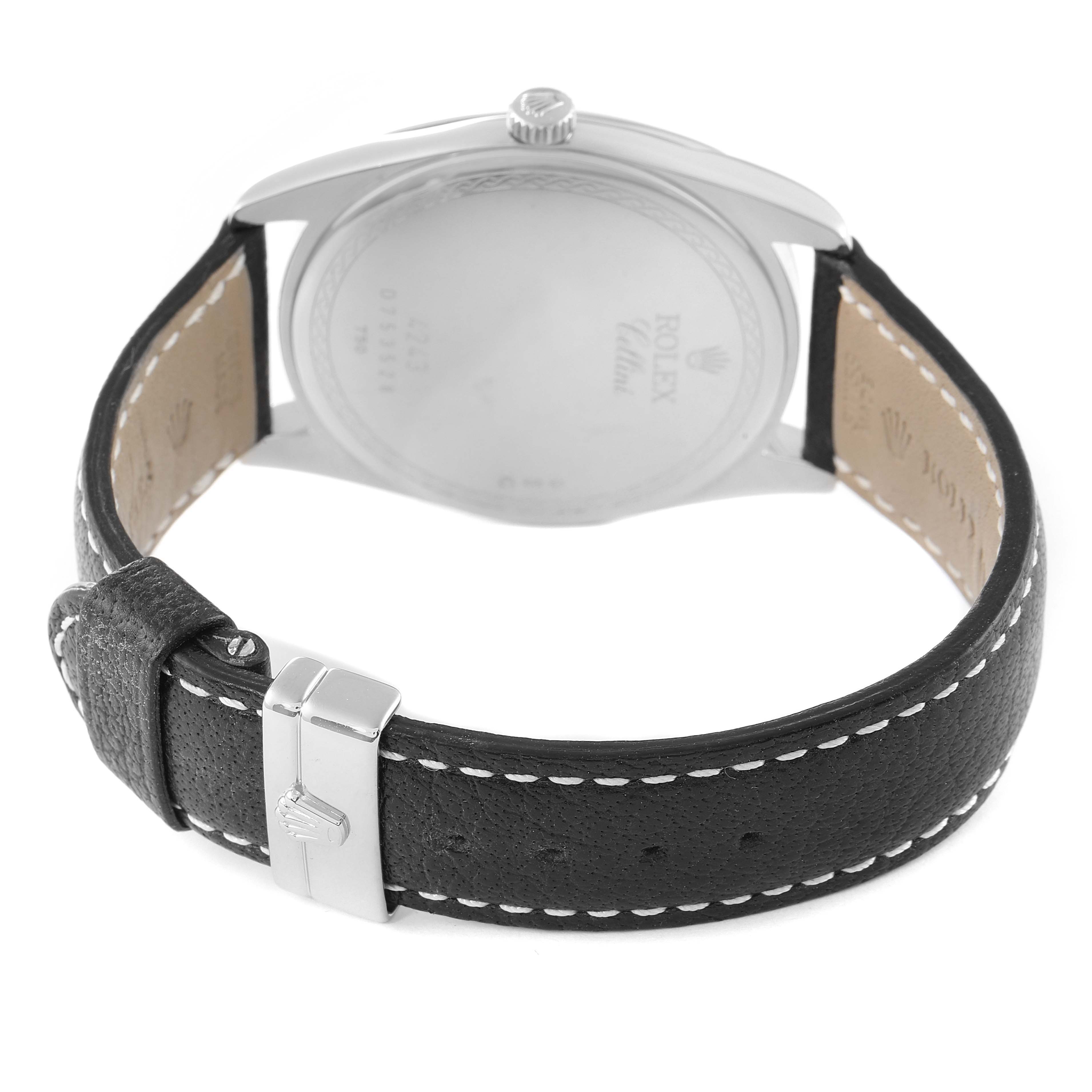 The image shows the back view of a Rolex Cellini 4243 Men
s White Gold Black Dial 4243 Men
s White Gold Black Dial watch, focusing on its caseback and leather strap with stitching.