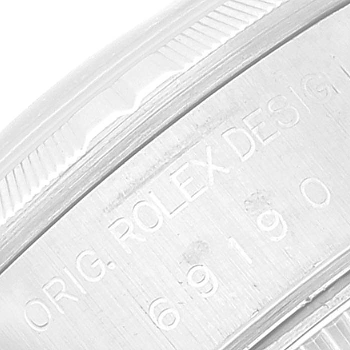 This image shows a close-up of the engraved bezel and serial number on a Rolex Datejust 69190 Women's Stainless Steel Silver Dial 69190 Women's Stainless Steel Silver Dial watch.