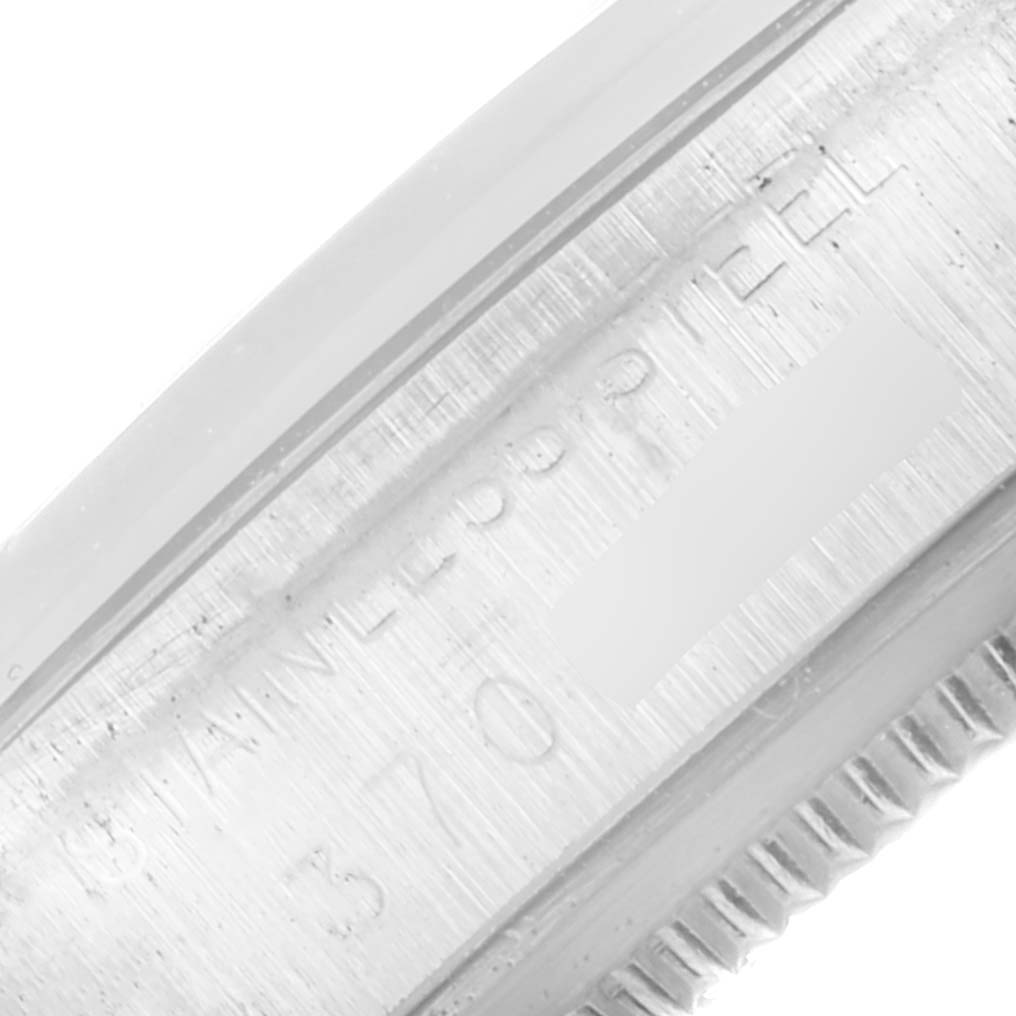 This image shows a close-up view of the side of the Rolex Vintage Collection 1500 Men's Stainless Steel Silver Dial 1500 Men's Stainless Steel Silver Dial model watch, specifically part of the case and serial number engraving.