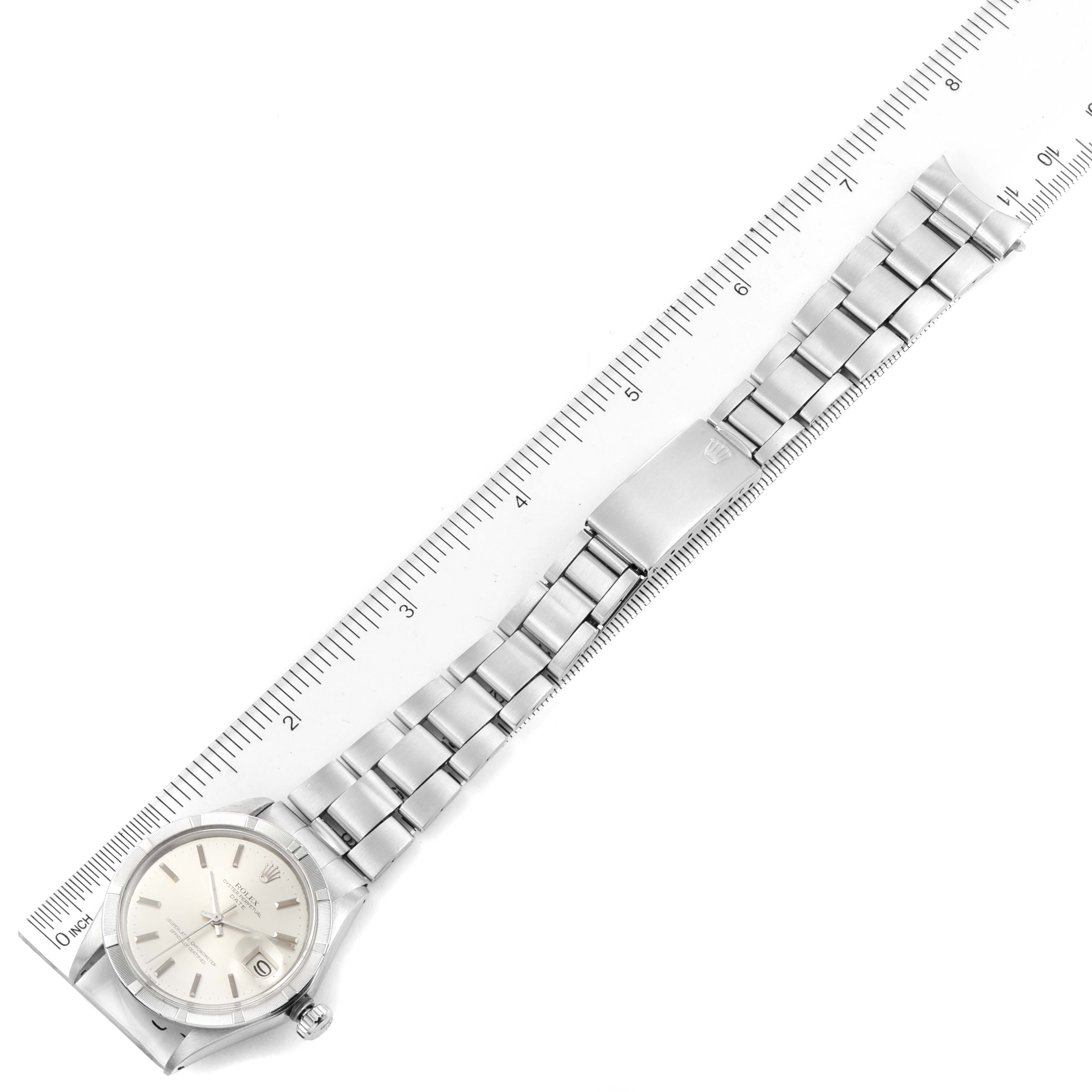 The image shows a top-down view of a Rolex Vintage Collection 1501 Men's Stainless Steel Silver Dial 1501 Men's Stainless Steel Silver Dial watch, displaying its face, bracelet, and clasp next to a ruler.