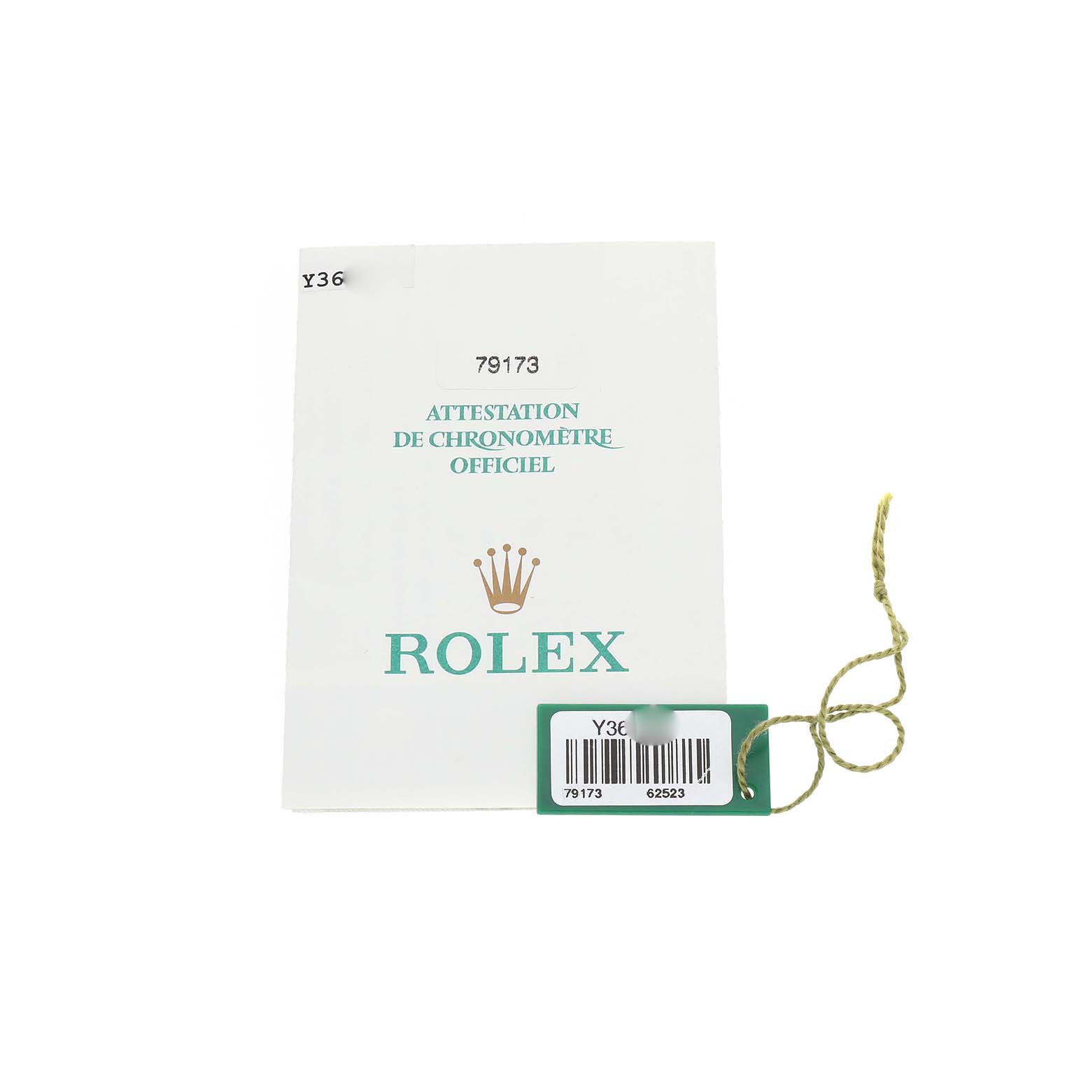The image shows a Rolex Datejust 79173 Women's Steel and Gold (two tone) White Dial document with a green tag attached by a string.