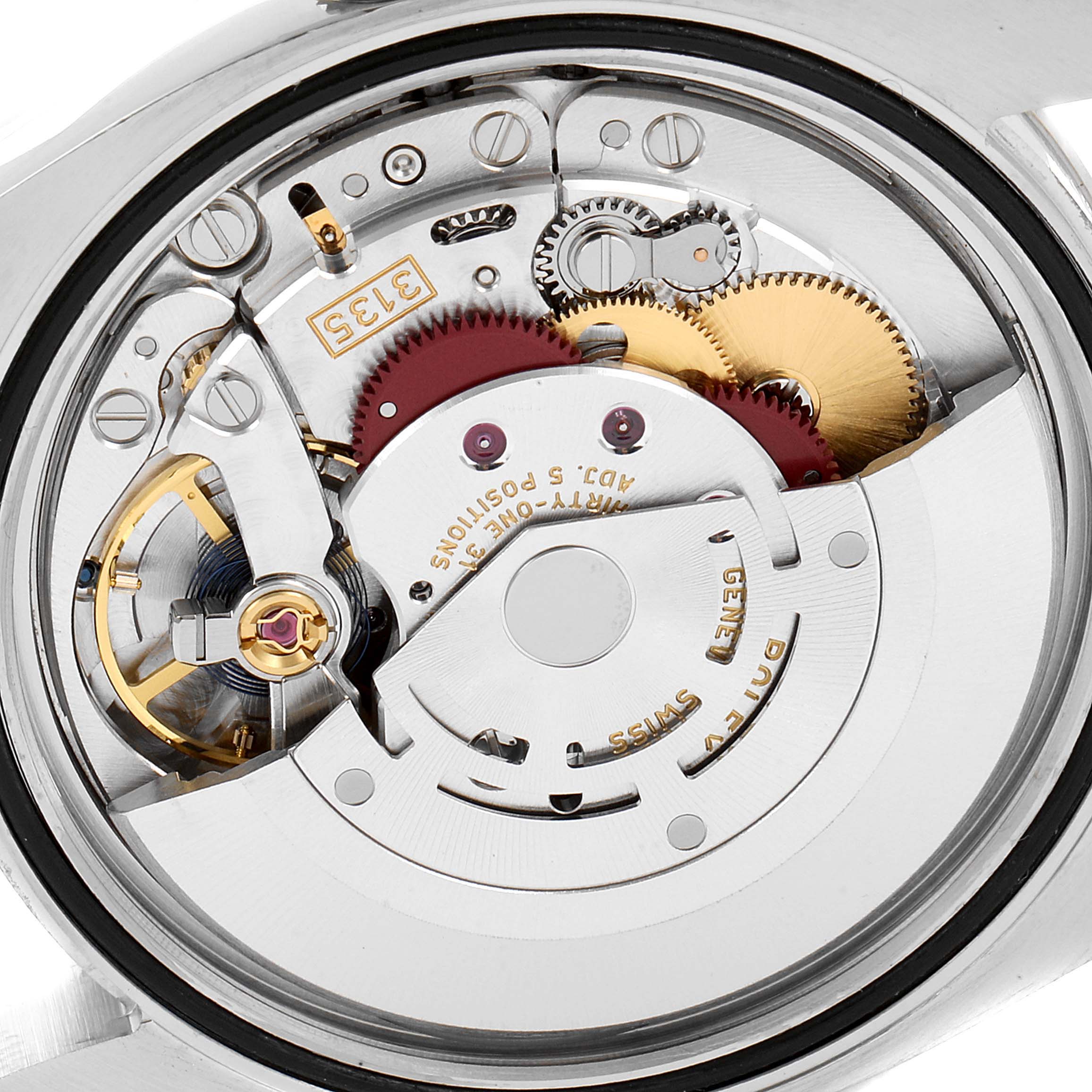 The image shows the intricate internal parts and mechanics of a Rolex Datejust 116244 Men
s Stainless Steel Black Dial 116244 Men
s Stainless Steel Black Dial watch from a close-up, rear angle.