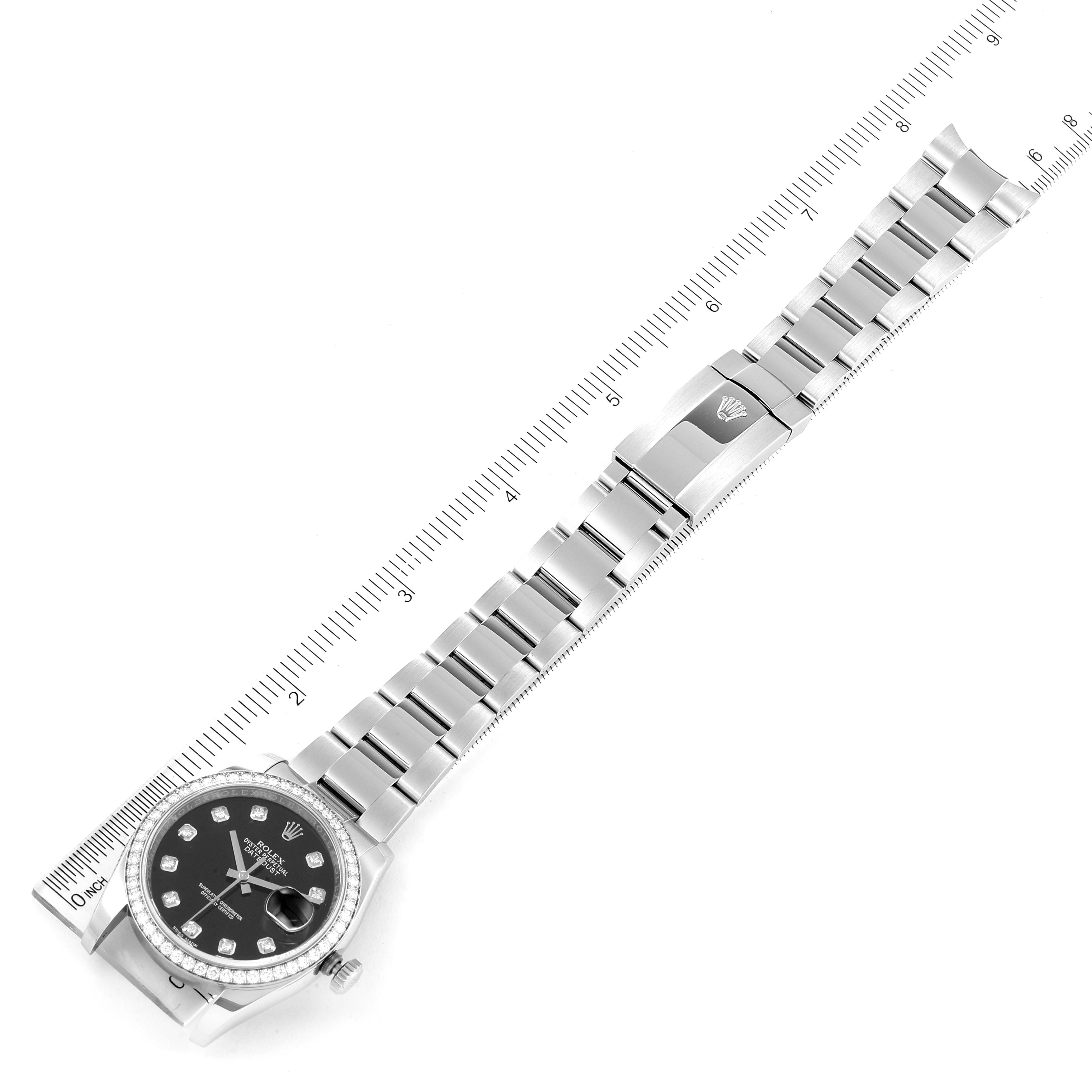 The Rolex Datejust 116244 Men
s Stainless Steel Black Dial 116244 Men
s Stainless Steel Black Dial watch is photographed from above, showing the entire bracelet and face next to a ruler for scale.