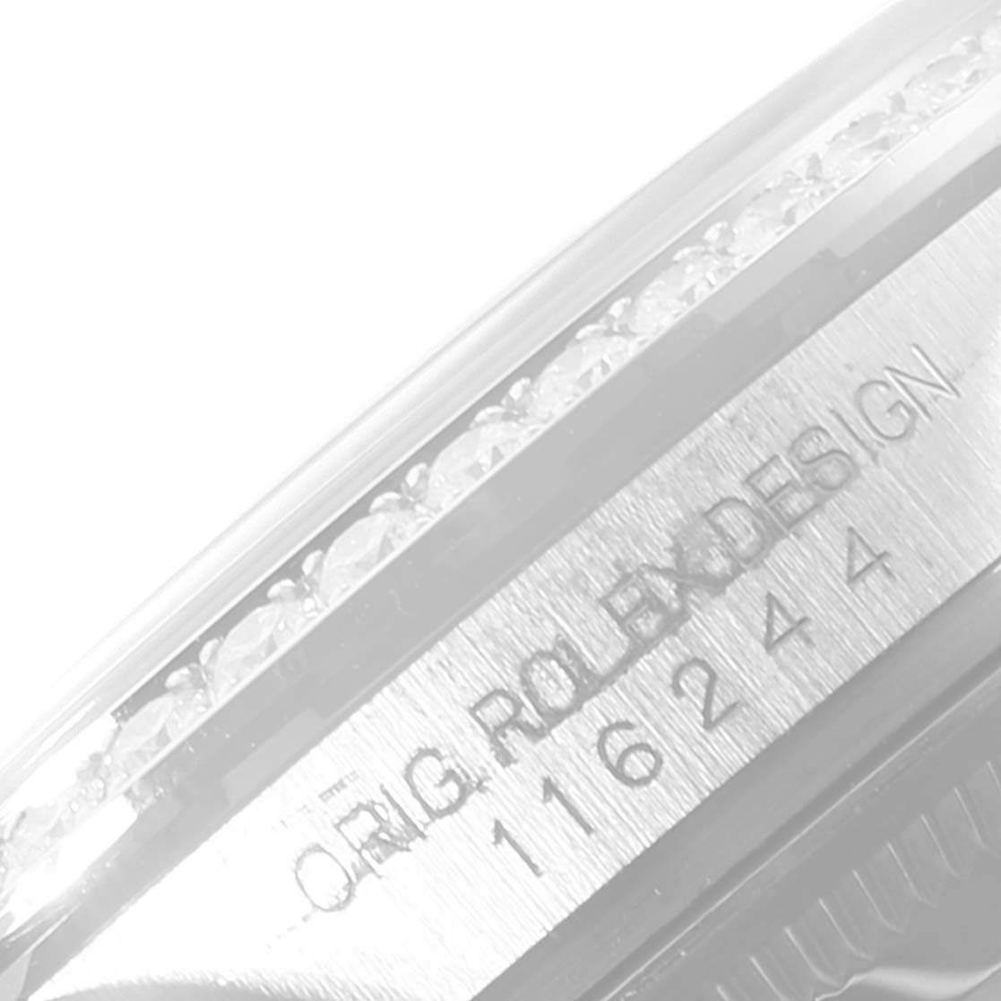This image shows a close-up of the case side of a Rolex Datejust 116244 Men
s Stainless Steel Black Dial 116244 Men
s Stainless Steel Black Dial watch, featuring the model number and "ORIG. ROLEX DESIGN" engraving.