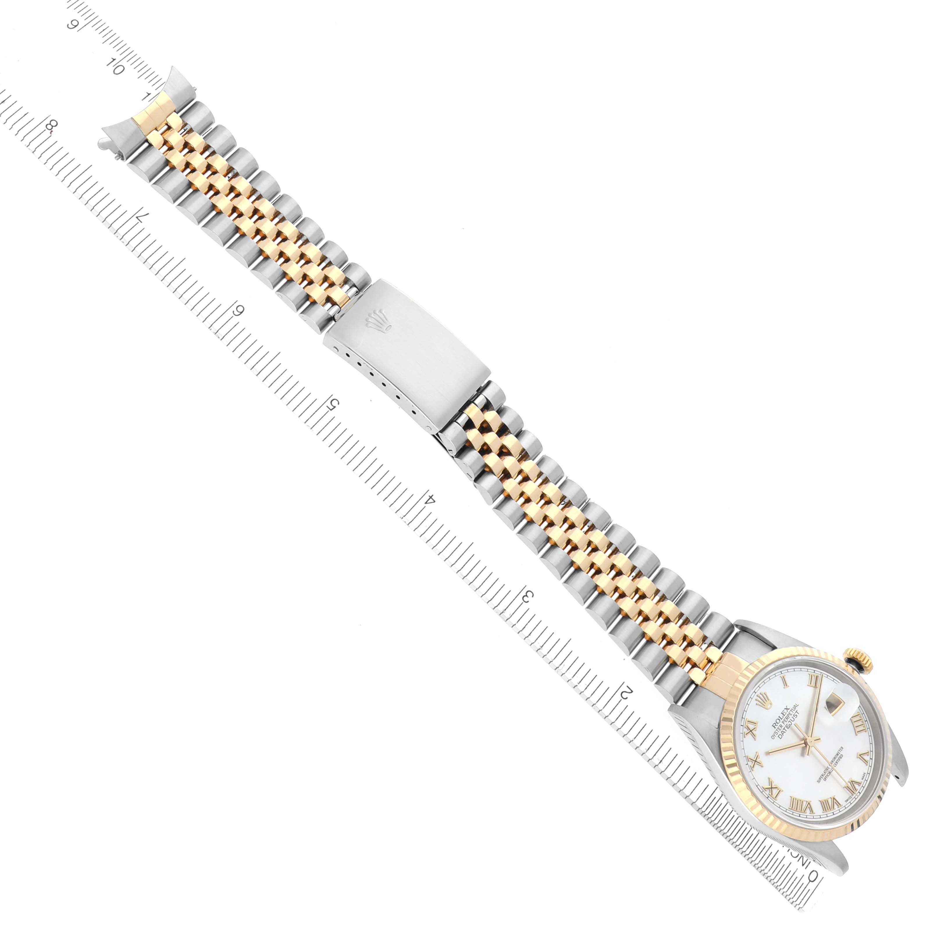 The image shows a Rolex Datejust 16233 Men's Steel and Gold (two tone) Mother of Pearl Dial 16233 Men's Steel and Gold (two tone) Mother of Pearl Dial watch at a diagonal angle with the full bracelet and clasp visible, alongside a ruler.