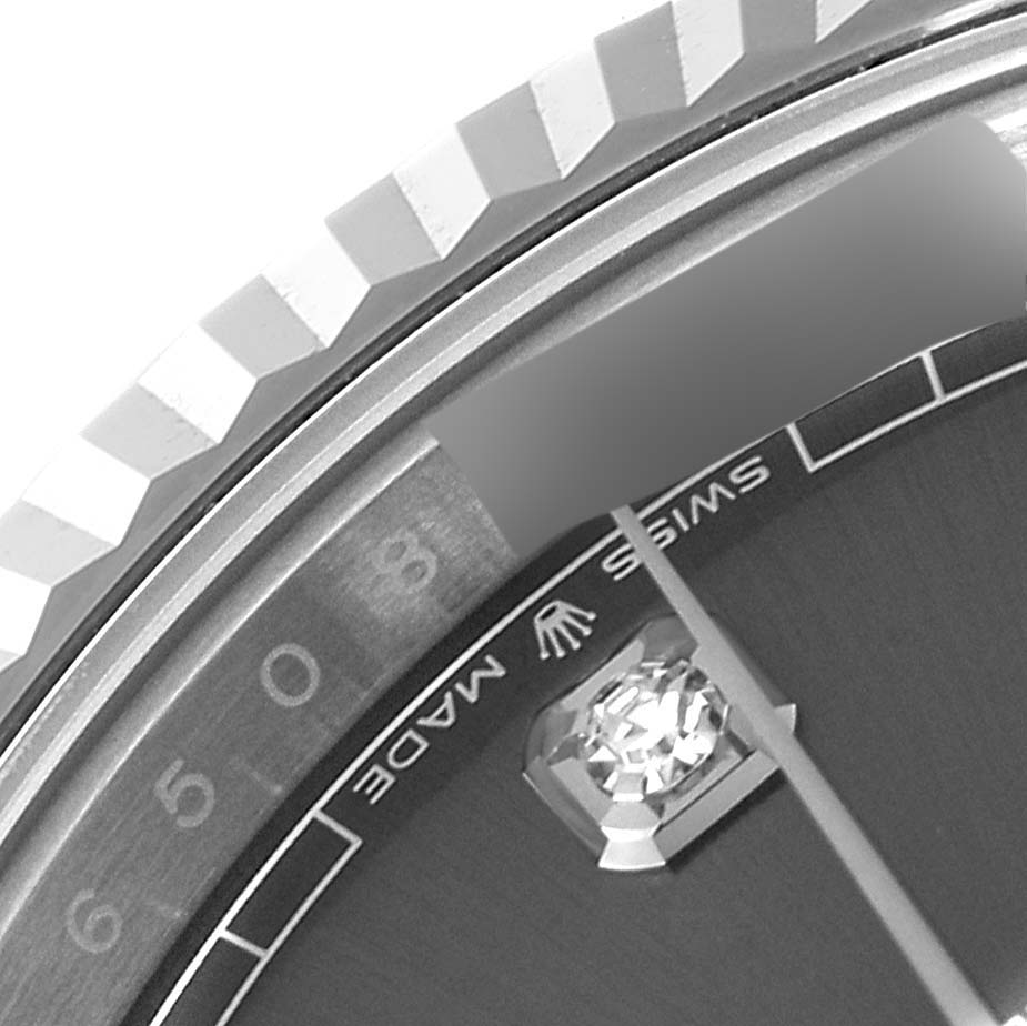 This close-up of the Rolex Datejust 41 126334 Men's Stainless Steel Grey Dial 126334 Men's Stainless Steel Grey Dial shows part of the bezel, dial, and diamond hour marker.