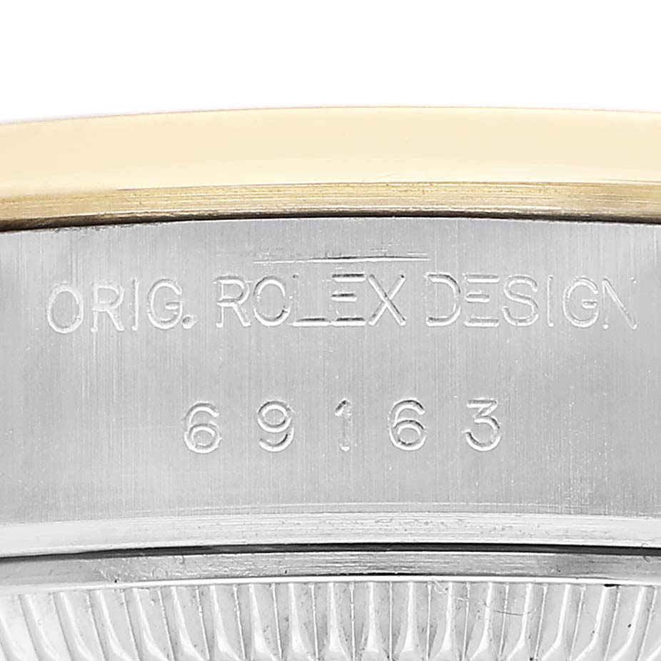 The image shows a close-up of the side of a Rolex Datejust 69163 Women's Steel and Gold (two tone) Champagne Dial, focusing on the engraved design number.
