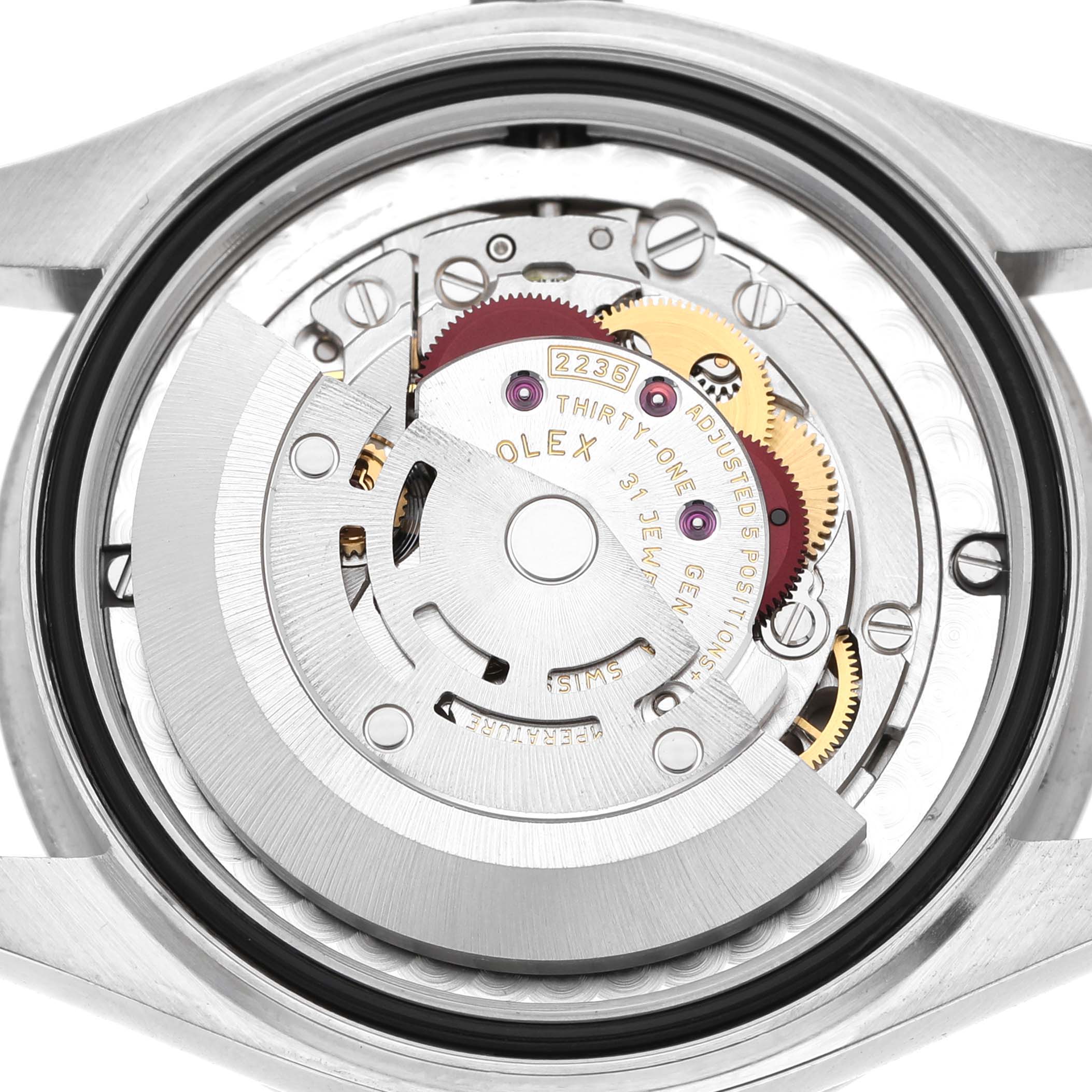 The image shows the movement of a Rolex Datejust 278384RBR Women's Stainless Steel Silver Dial, viewed from the back, highlighting gears and the oscillating weight.