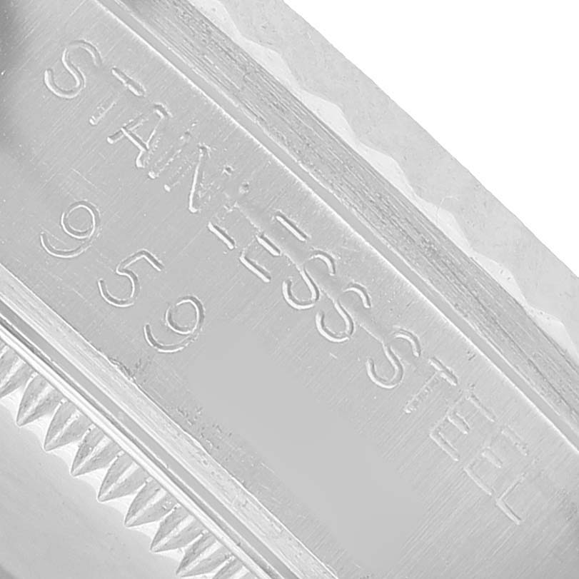 The image shows a close-up of the side of a Rolex Datejust 68274 Men's Stainless Steel Orange Dial watch, highlighting the edge and material inscription.