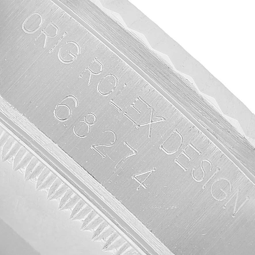 The image shows a close-up of the side engraving on a Rolex Datejust 68274 Men's Stainless Steel Orange Dial watch case.