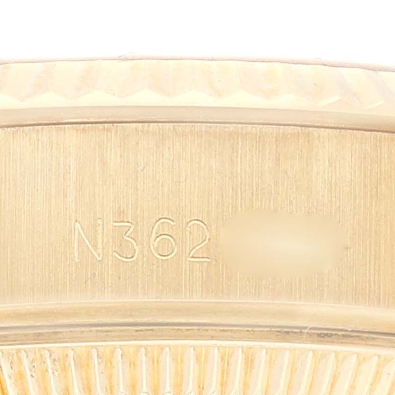 This image shows a close-up of the side engraving near the bezel of a Rolex President 69178 Women's Yellow Gold Champagne Dial 69178 Women's Yellow Gold Champagne Dial model watch.