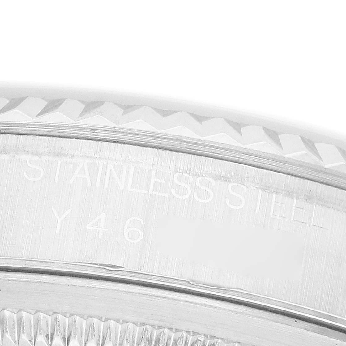 The image shows a close-up side view of the bezel and engraved text on a Rolex Datejust 16234 Men's White Gold Silver Dial watch.