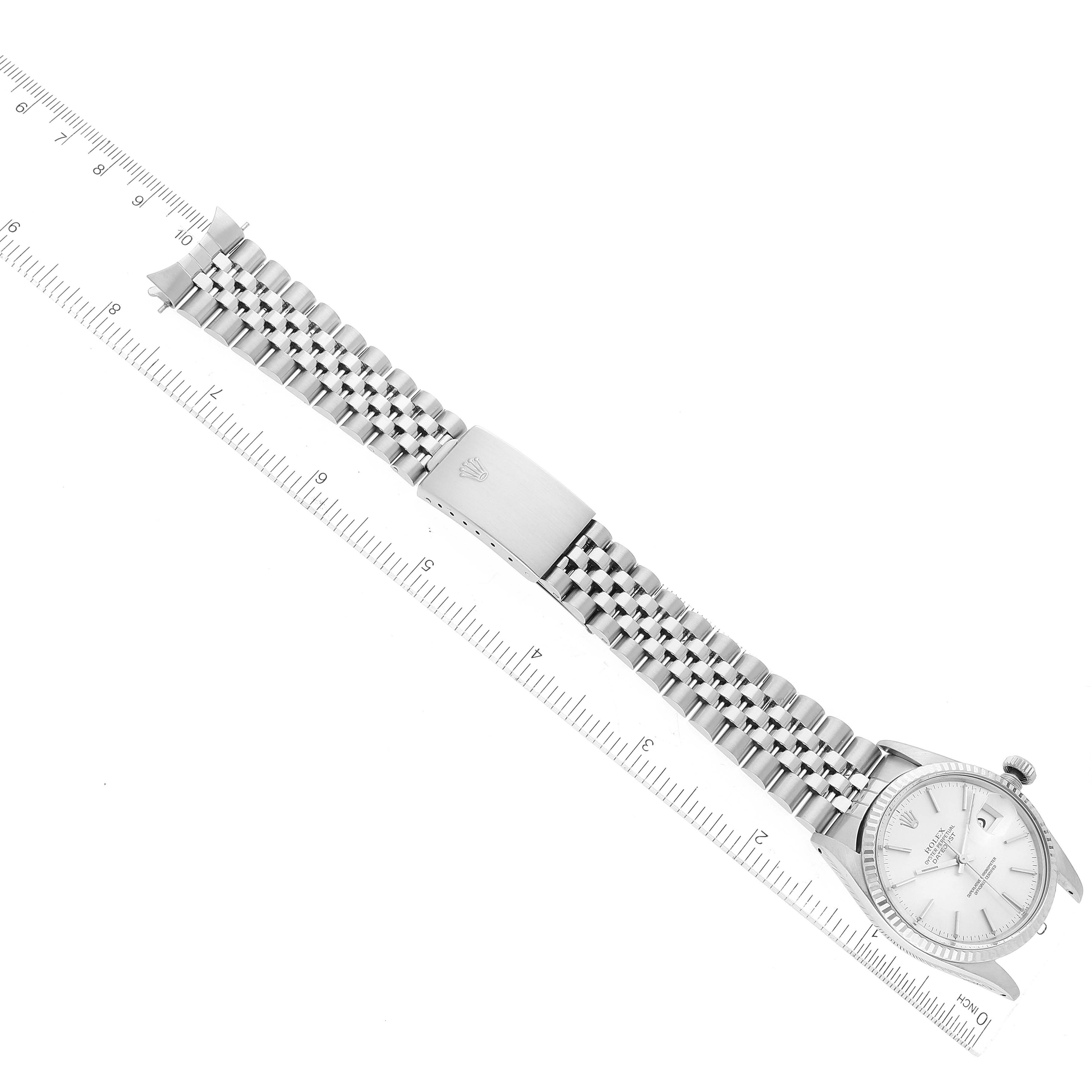 The image shows a Rolex Vintage Collection 16014 Men
s Stainless Steel Silver Dial 16014 Men
s Stainless Steel Silver Dial watch viewed from above, featuring its bracelet, clasp, and face with a ruler for scale.