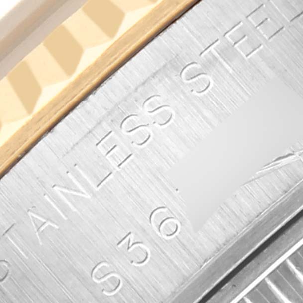 The image shows a close-up of the edge of a Rolex Datejust 69173 Women's Steel and Gold (two tone) Champagne Dial 69173 Women's Steel and Gold (two tone) Champagne Dial watch, highlighting the stainless steel case and part of the bezel.
