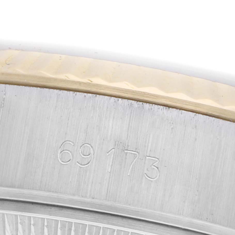The close-up view shows the side of the Rolex Datejust 69173 Women's Steel and Gold (two tone) Champagne Dial 69173 Women's Steel and Gold (two tone) Champagne Dial model, highlighting the serial number engravings on the metal.